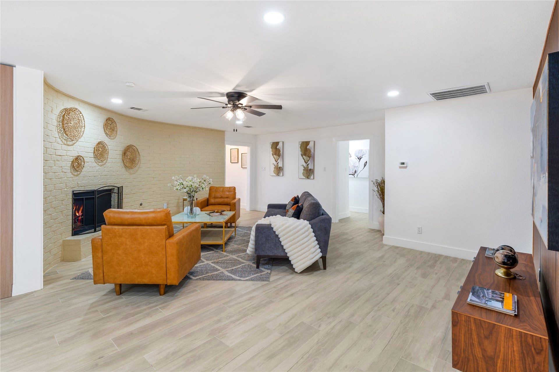 6203 Cheena Drive, Houston, TX 77096 Spacious living area with tile flooring, a fireplace, and an open layout.