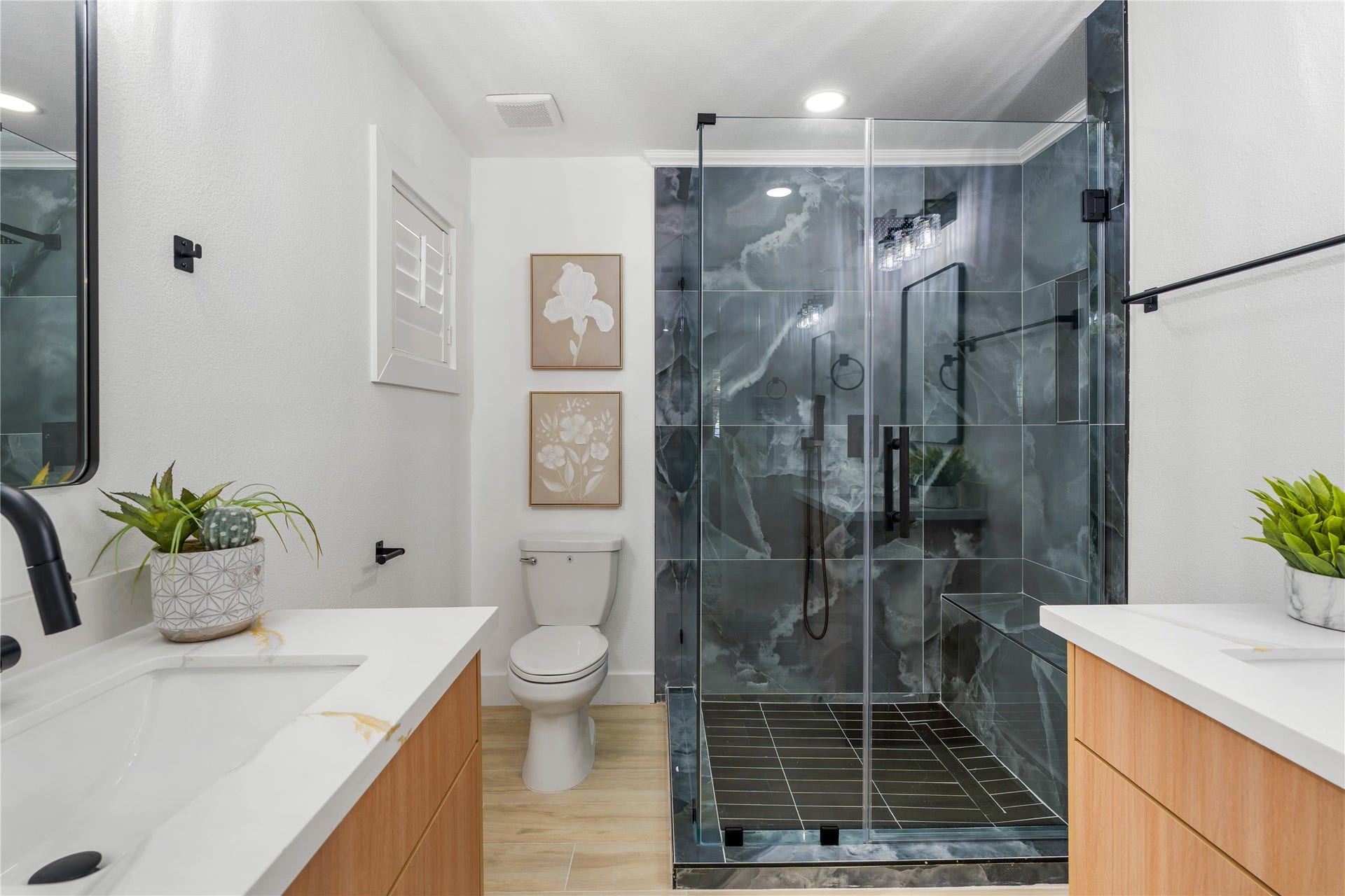 6203 Cheena Drive, Houston, TX 77096 Updated primary bathroom featuring a glass-enclosed shower, ample vanity space, and a modern, functional design.