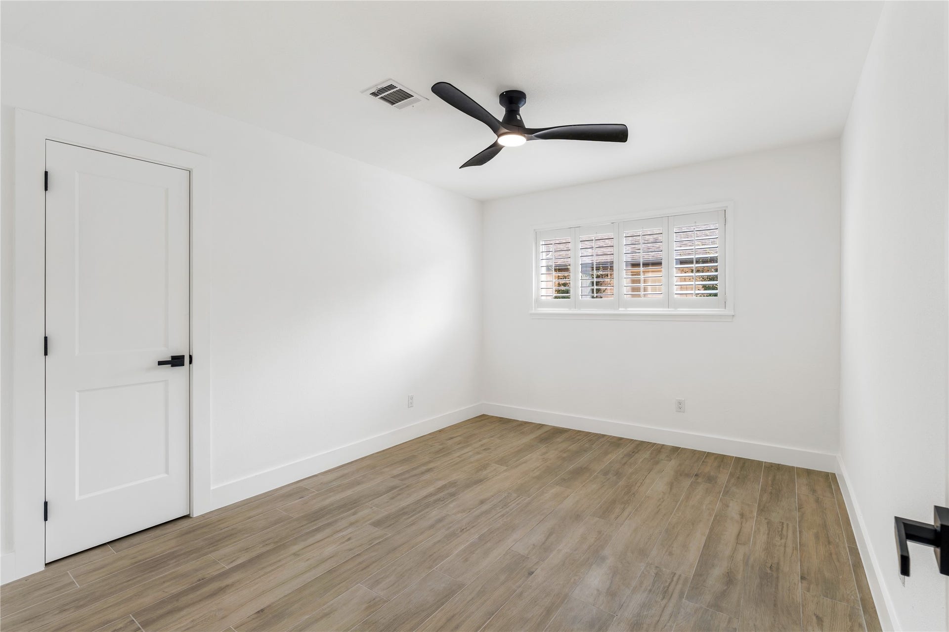 6203 Cheena Drive, Houston, TX 77096 Spacious bedroom with tile flooring, a ceiling fan, and a simple, versatile layout.