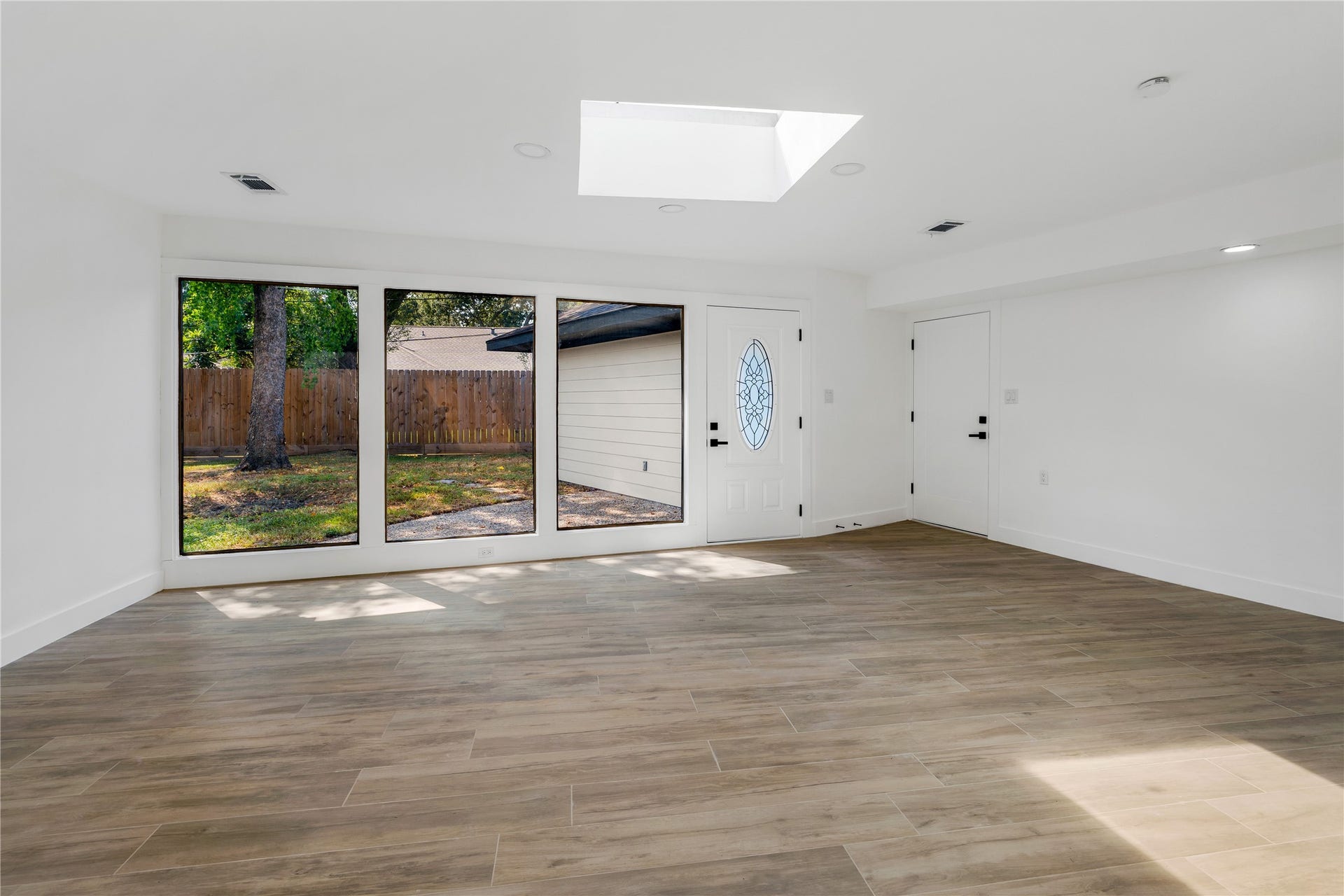 6203 Cheena Drive, Houston, TX 77096 Bright and spacious flex room with tile flooring, large windows, and abundant natural light.