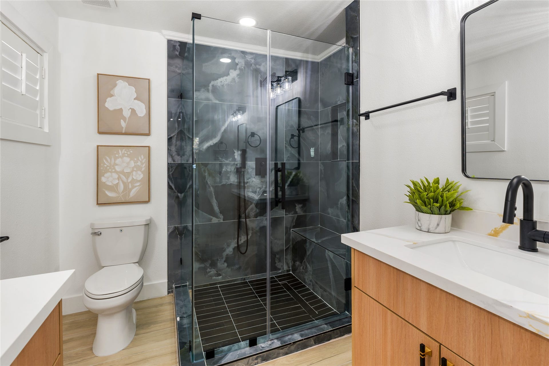 6203 Cheena Drive, Houston, TX 77096 Spacious bathroom featuring a glass-enclosed shower, ample vanity space, and a functional layout.