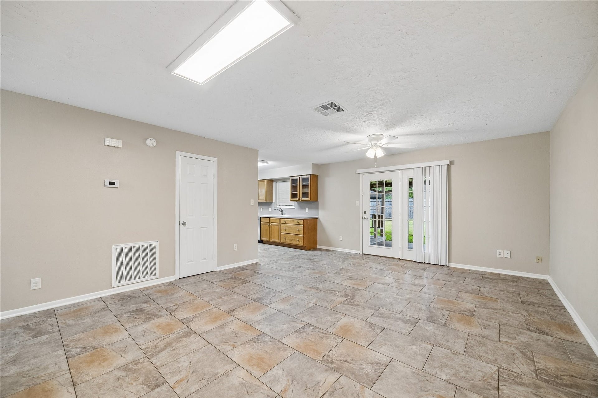 1110 E Rutgers Lane, Deer Park, TX 77536 The living room is right off the entryway. Doors leading to the back yard and the kitchen on the left.