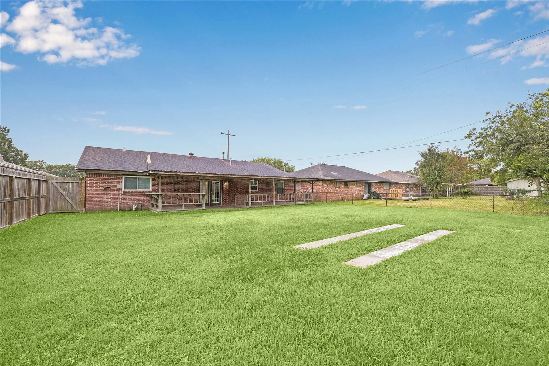 1110 E Rutgers Lane, Deer Park, TX 77536 Rear Elevation of home. Back yard is fully fenced. Large covered back patio and deck. Plenty of room for patio furniture.