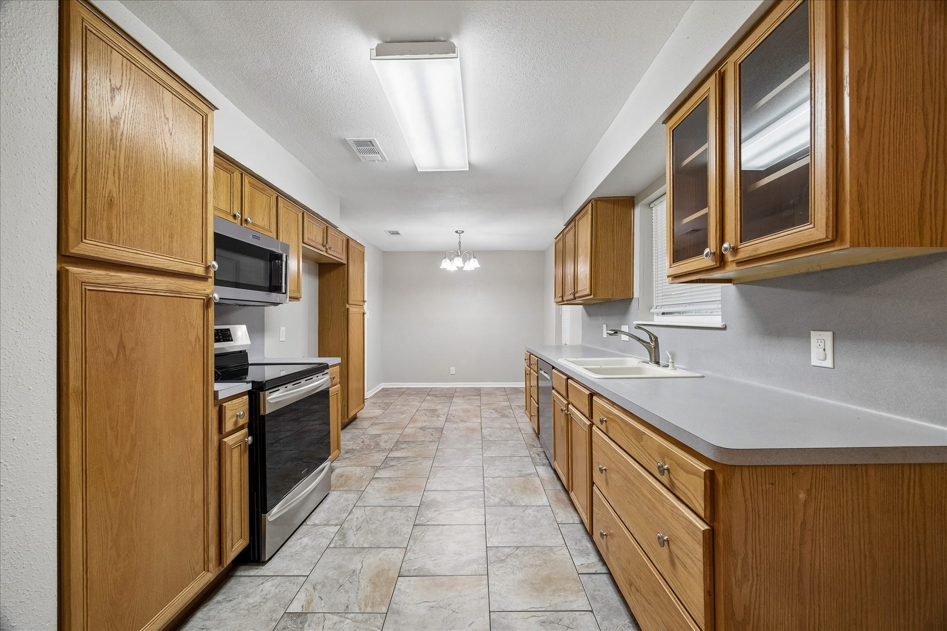 1110 E Rutgers Lane, Deer Park, TX 77536 Kitchen with plenty of storage and window above the sink overlooking the backyard. Breakfast area off the back of kitchen.