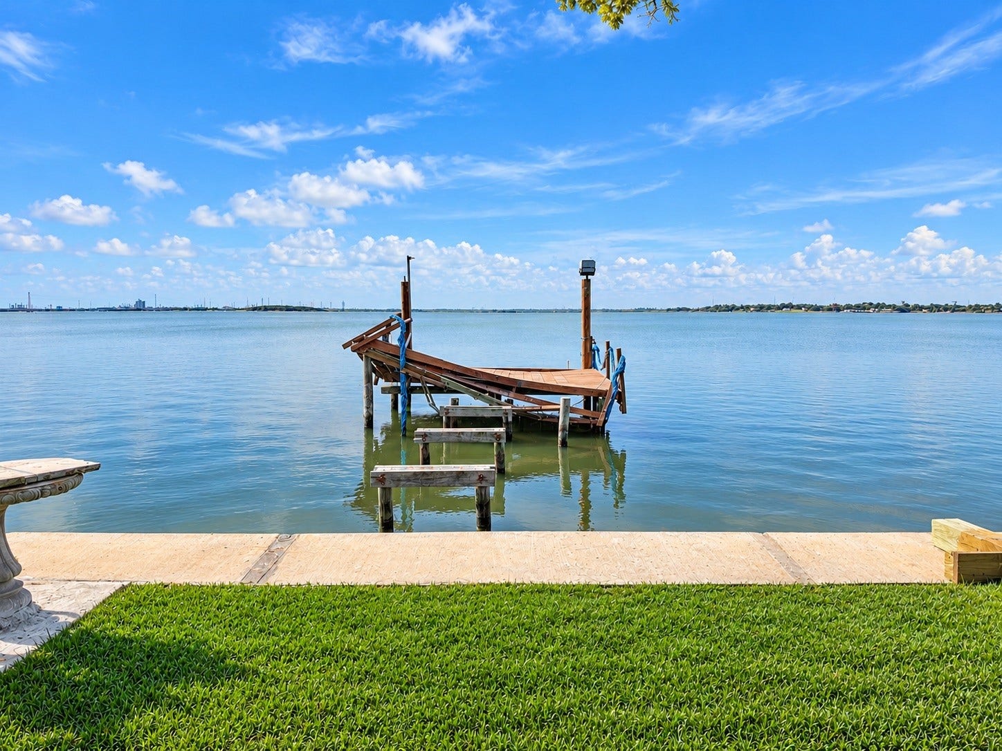 Serene waterfront view with a private dock, perfect for enjoying tranquil lakefront living.