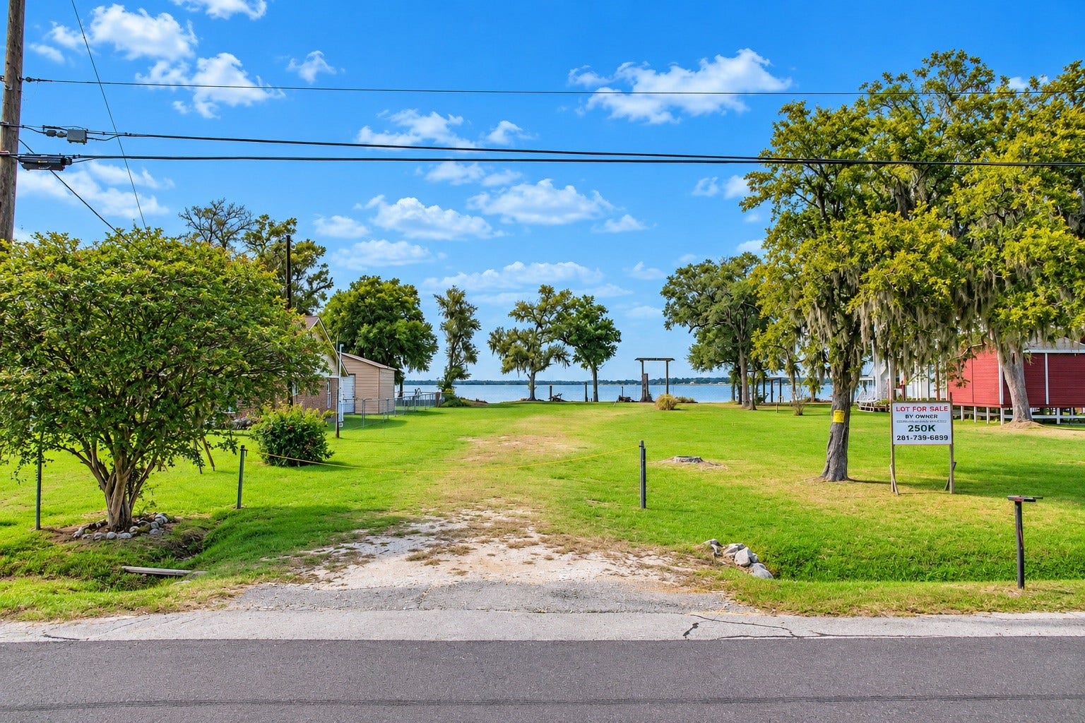 Prime waterfront lot with lush greenery, mature trees, and stunning lake views, perfect for your dream home.