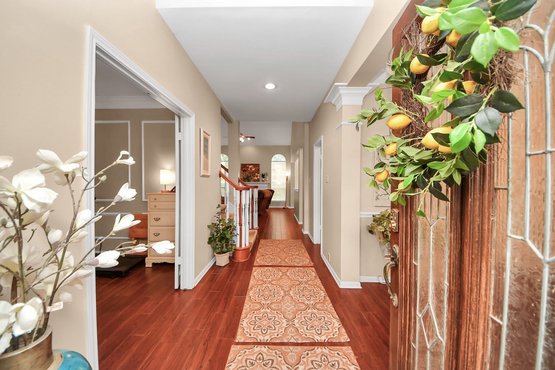7015 Morningside Drive, Sugar Land, TX 77479 Inviting entryway with elegant hardwood flooring, tasteful decor, and abundant natural light leading to a cozy living area.