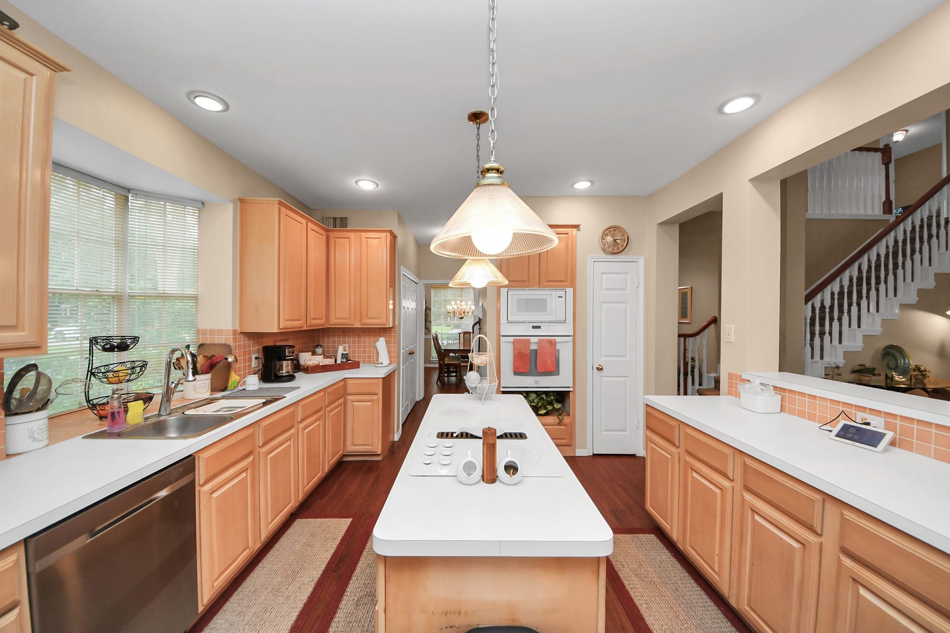 7015 Morningside Drive, Sugar Land, TX 77479 Spacious kitchen with warm wood cabinetry, ample counter space, and a central island, perfect for culinary enthusiasts.