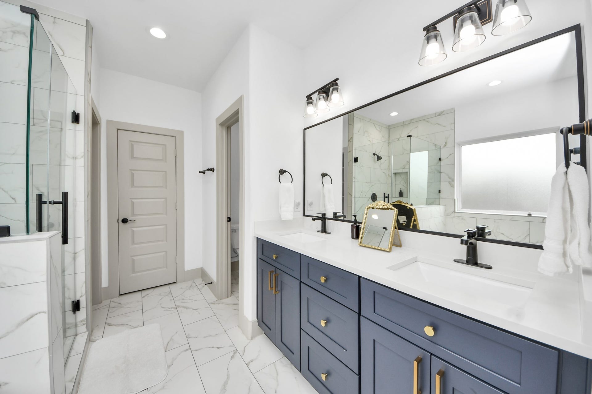 837 W Little York Road, Houston, TX 77091 Contemporary primary bathroom featuring modern fixtures, generous vanity space, and clean designer finishes.