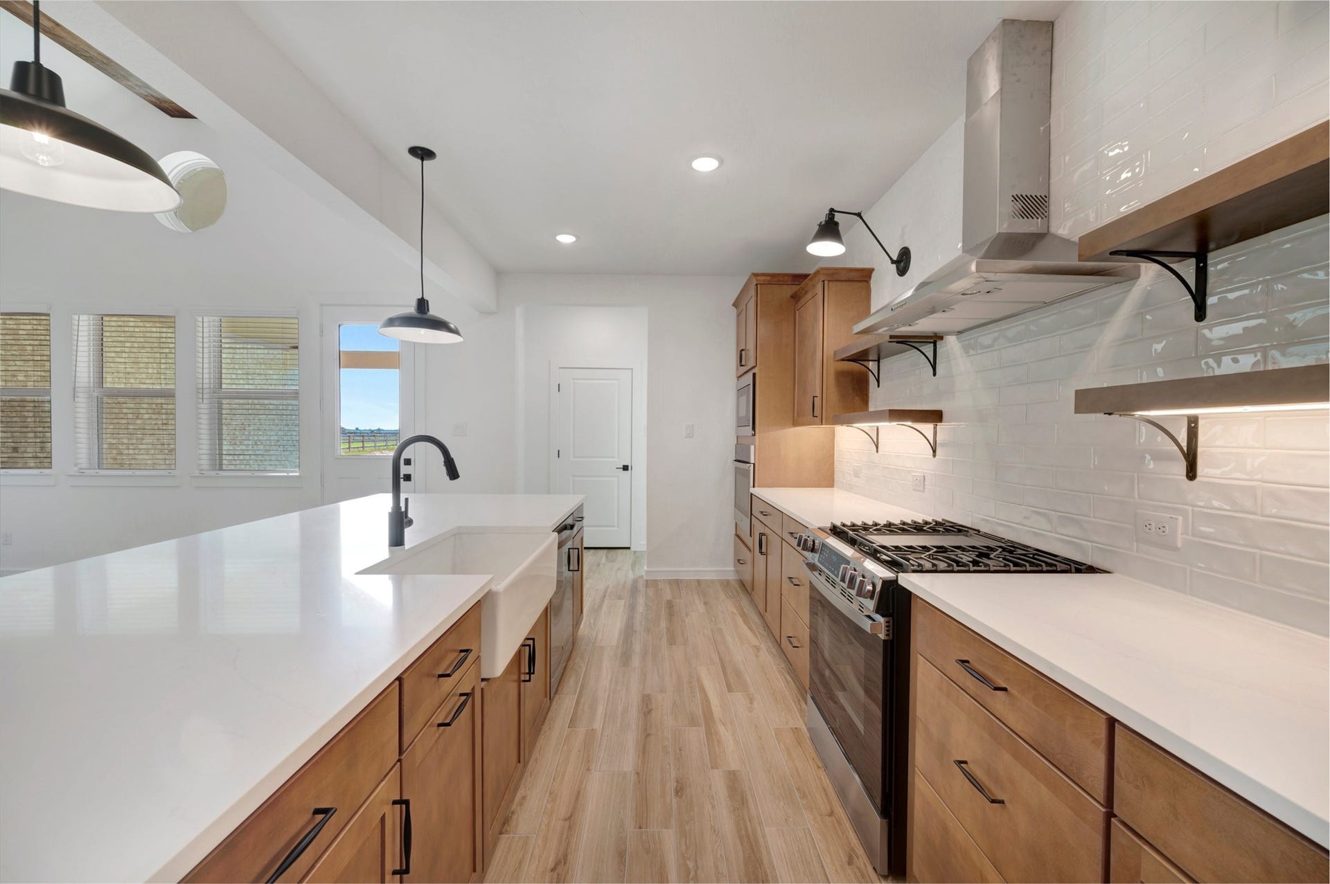 4005 Cardinal Way, Waller, TX 77484 Stylish kitchen with light stain cabinets and floating shelves