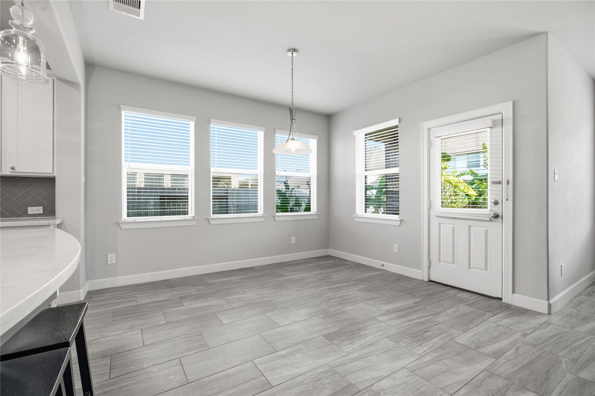 1717 Oakdale Mist Drive, Dickinson, TX 77539 Bright breakfast area surrounded by windows, offering plenty of natural light and a convenient space for everyday dining just off the kitchen.