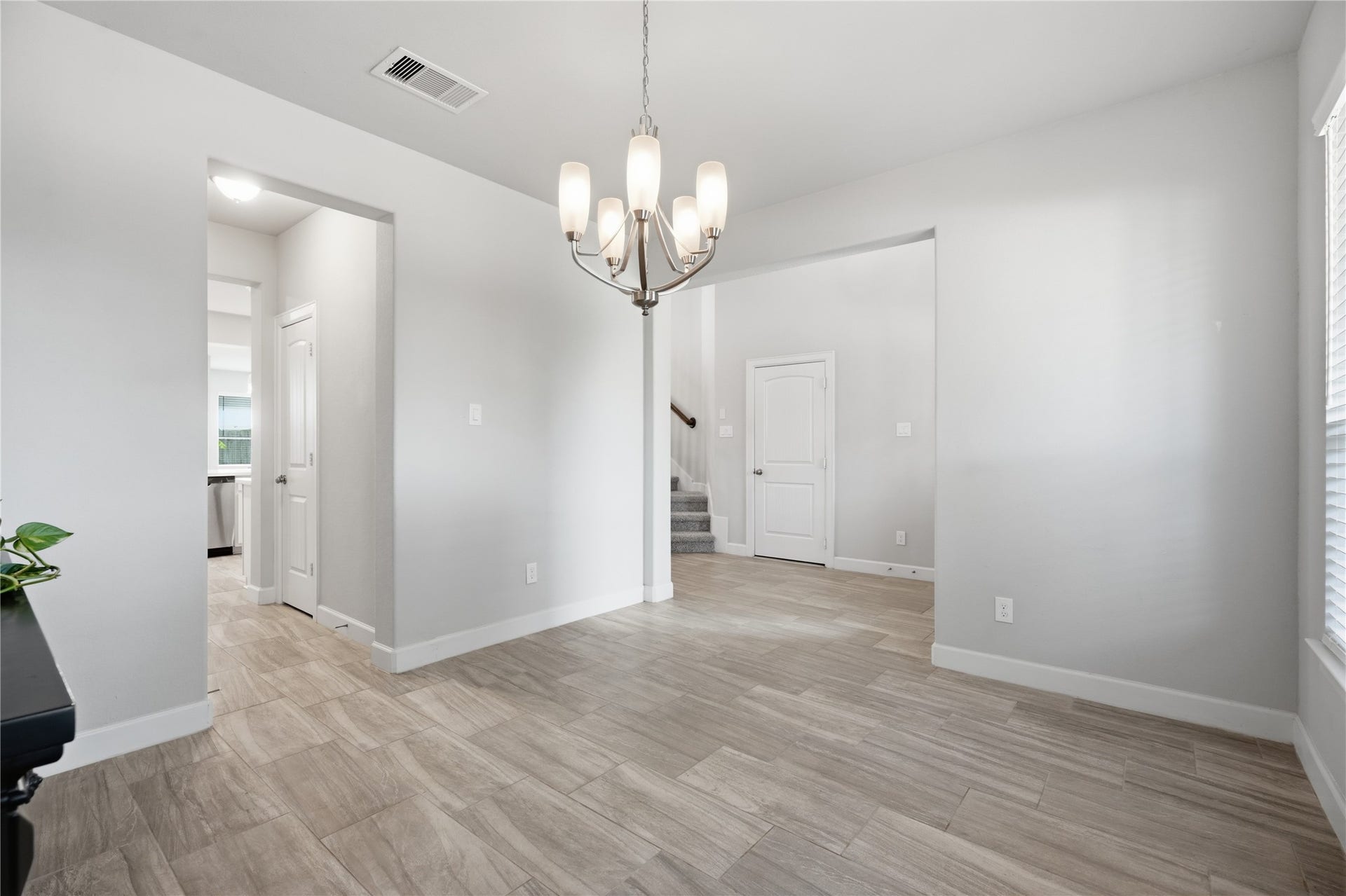 1717 Oakdale Mist Drive, Dickinson, TX 77539 A closer look at the formal dining room featuring tile flooring, abundant natural light, neutral finishes, and convenient access to the kitchen and main living spaces.