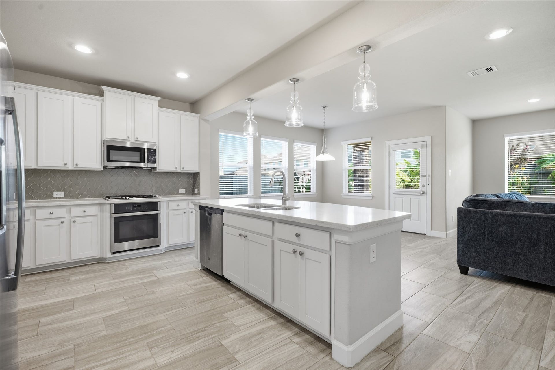 1717 Oakdale Mist Drive, Dickinson, TX 77539 The kitchen offers an open, functional layout with ample storage and counter space, stainless steel appliances, and easy flow into the surrounding living areas.
