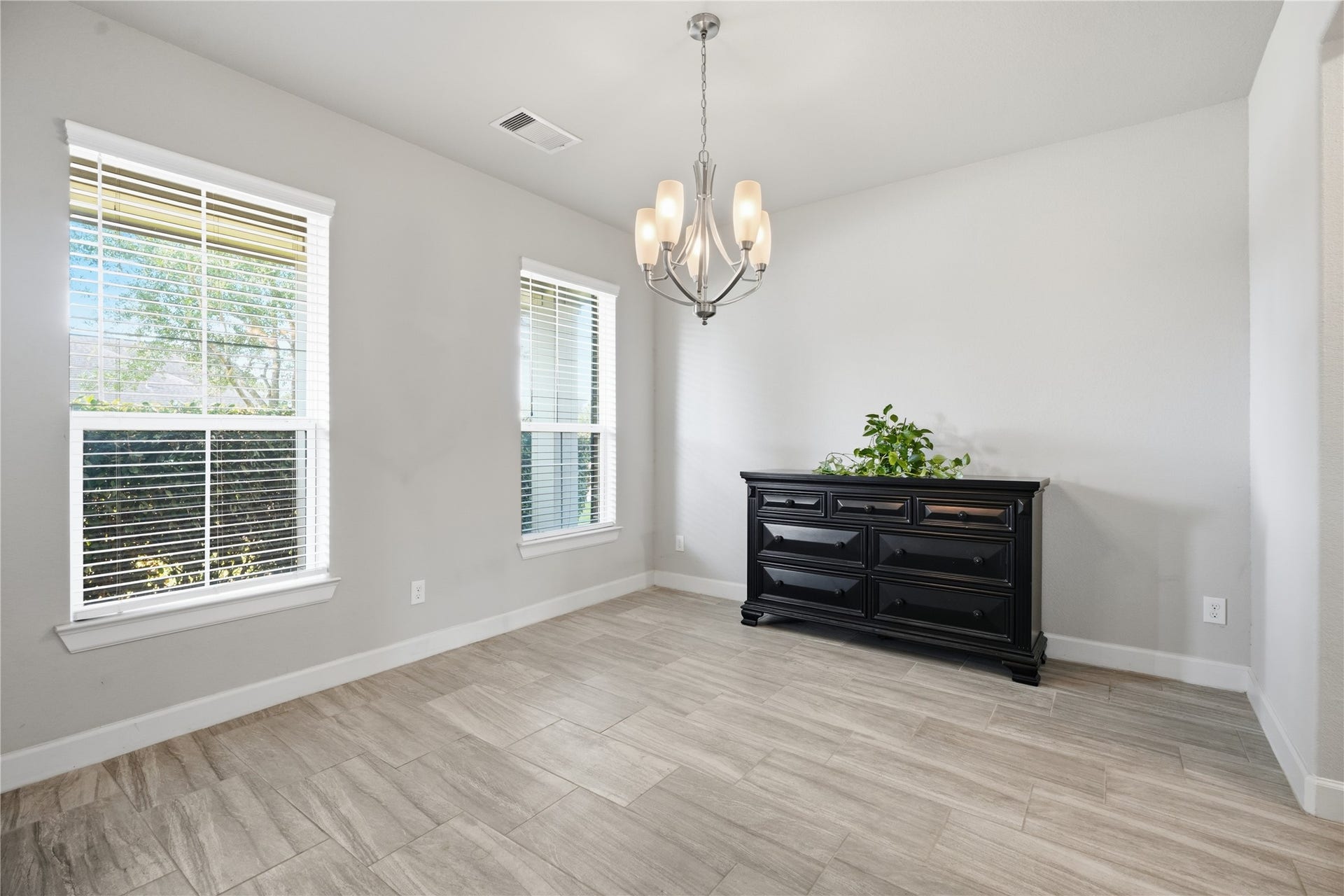 1717 Oakdale Mist Drive, Dickinson, TX 77539 The entry opens to a spacious formal dining area with tile flooring and plenty of room for gatherings.