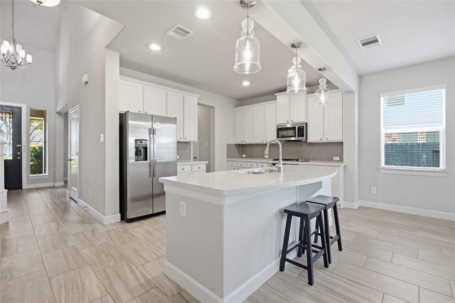1717 Oakdale Mist Drive, Dickinson, TX 77539 Another view of the kitchen highlights the expansive island with bar seating and plenty of workspace for cooking, serving, and gathering.