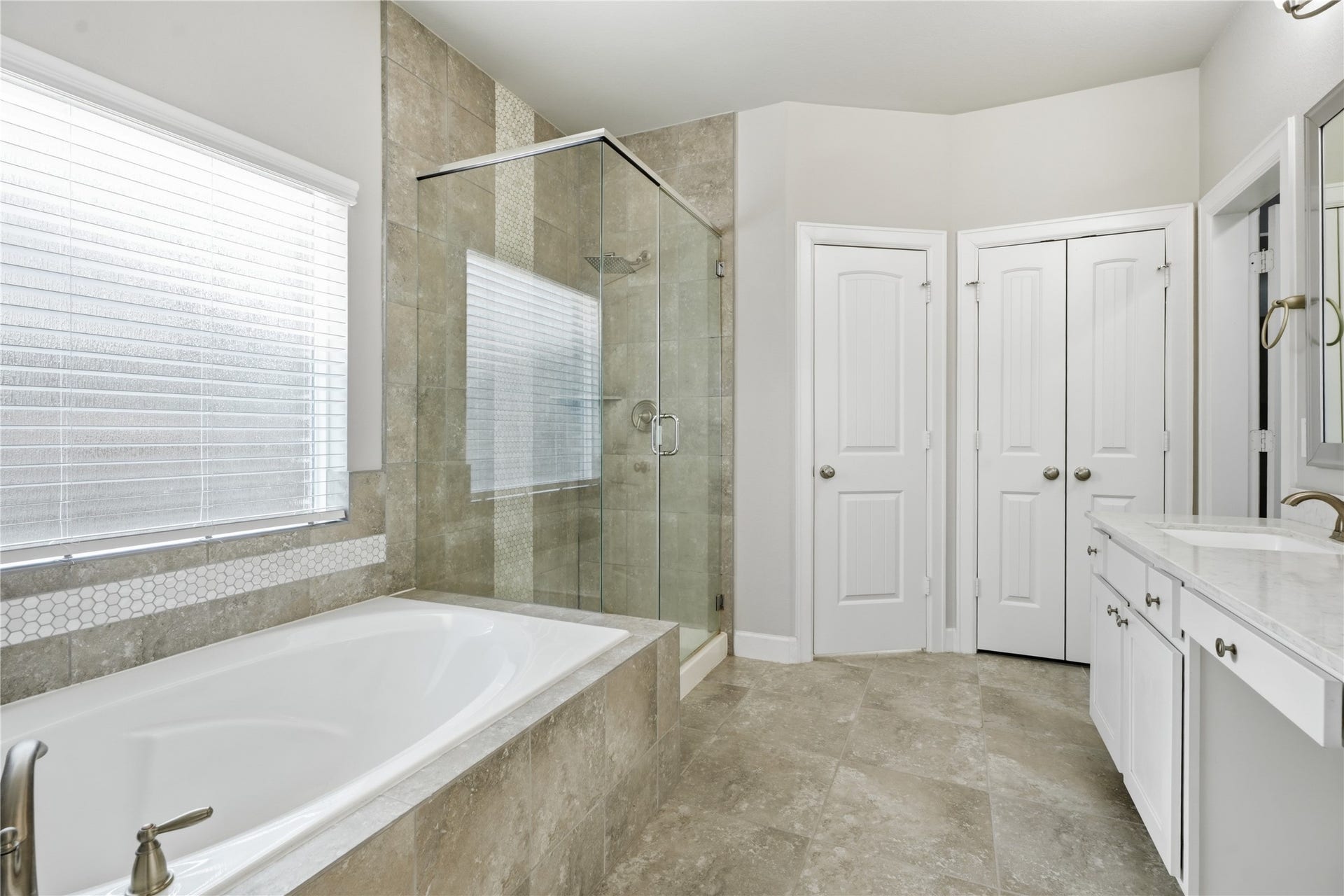 1717 Oakdale Mist Drive, Dickinson, TX 77539 The primary bathroom offers a functional layout with dual sinks, generous cabinetry, updated fixtures, and plenty of room to start and end your day.