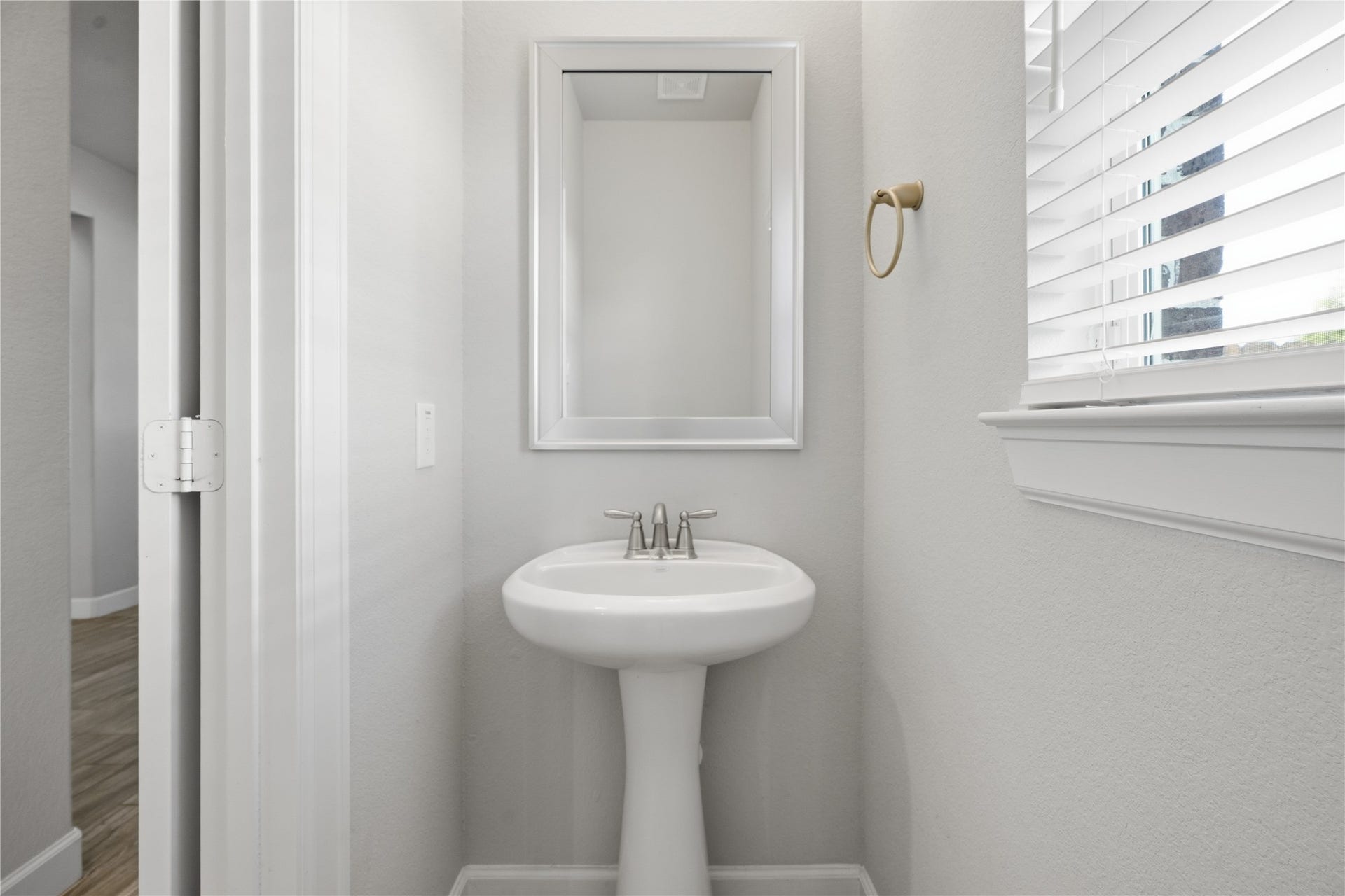 1717 Oakdale Mist Drive, Dickinson, TX 77539 Conveniently located half bath downstairs features an updated vanity, mirror, and fixtures for a polished, modern look.