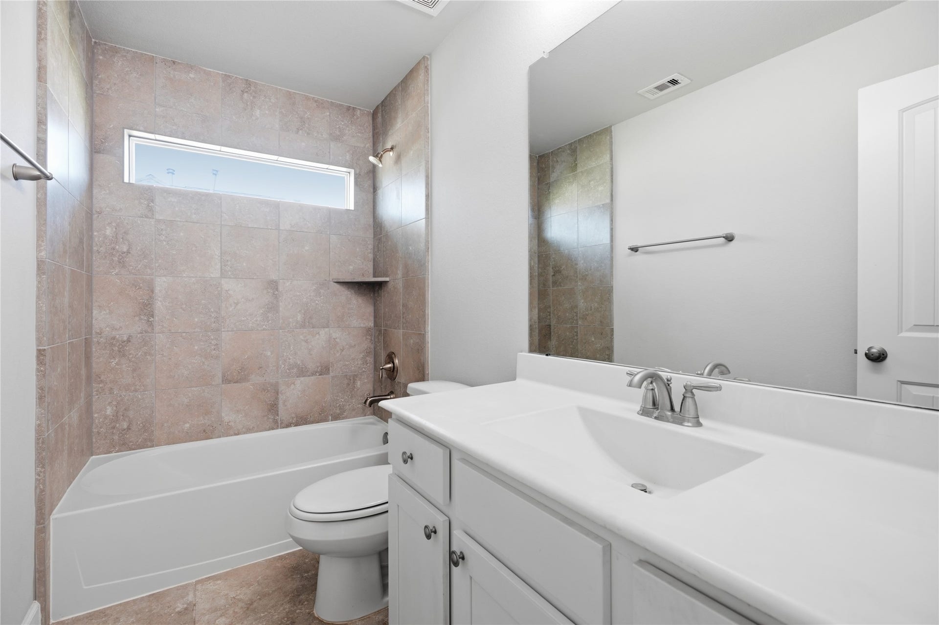 1717 Oakdale Mist Drive, Dickinson, TX 77539 Additional upstairs bedroom featuring a large window, natural light, and convenient access to the nearby full bathroom and game room.