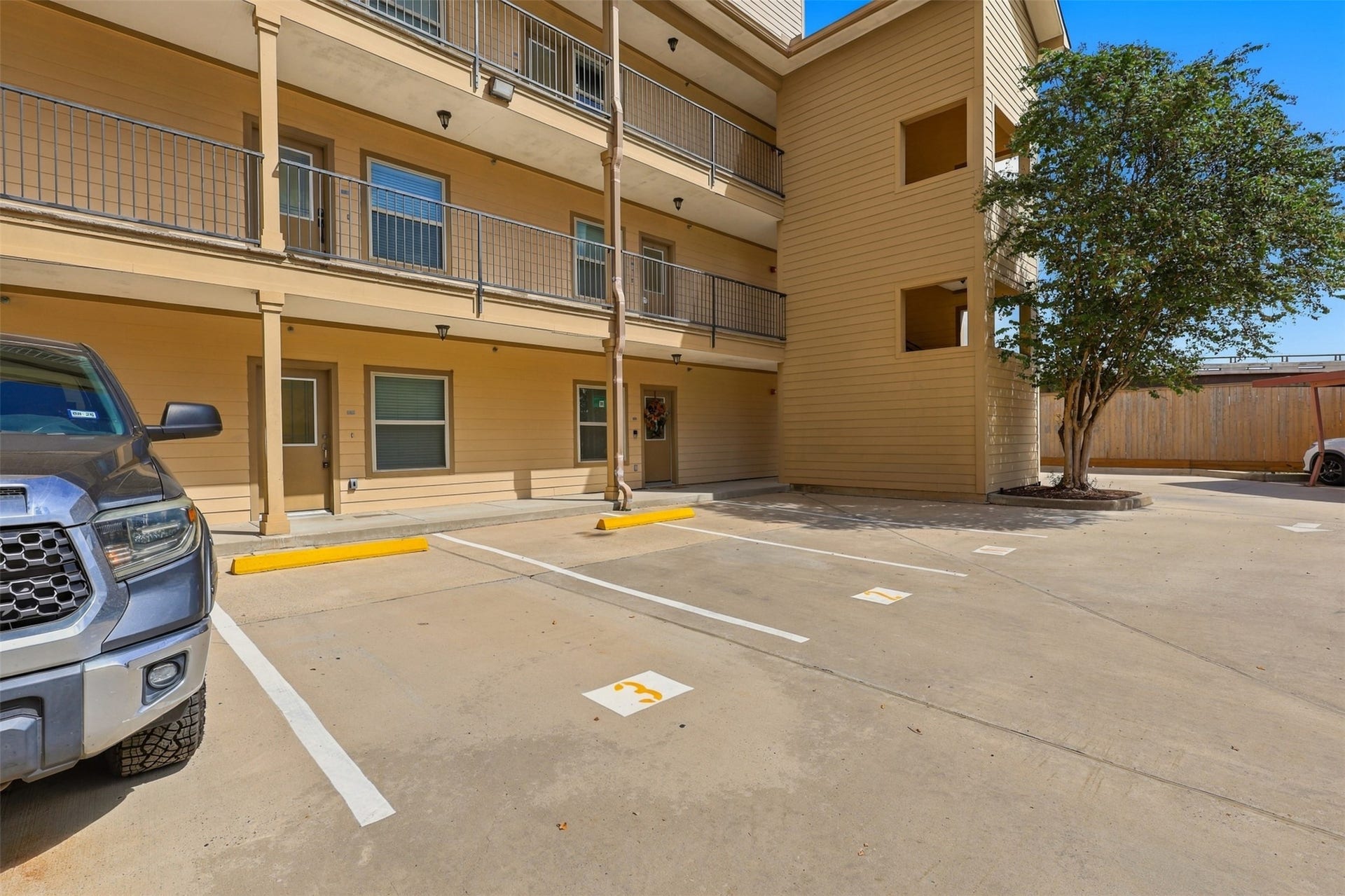 3501 Chenevert Street, #3, Houston, TX 77004 Convenient and spacious parking area adjacent to a well-maintained multi-level building, offering easy access and a welcoming entrance.