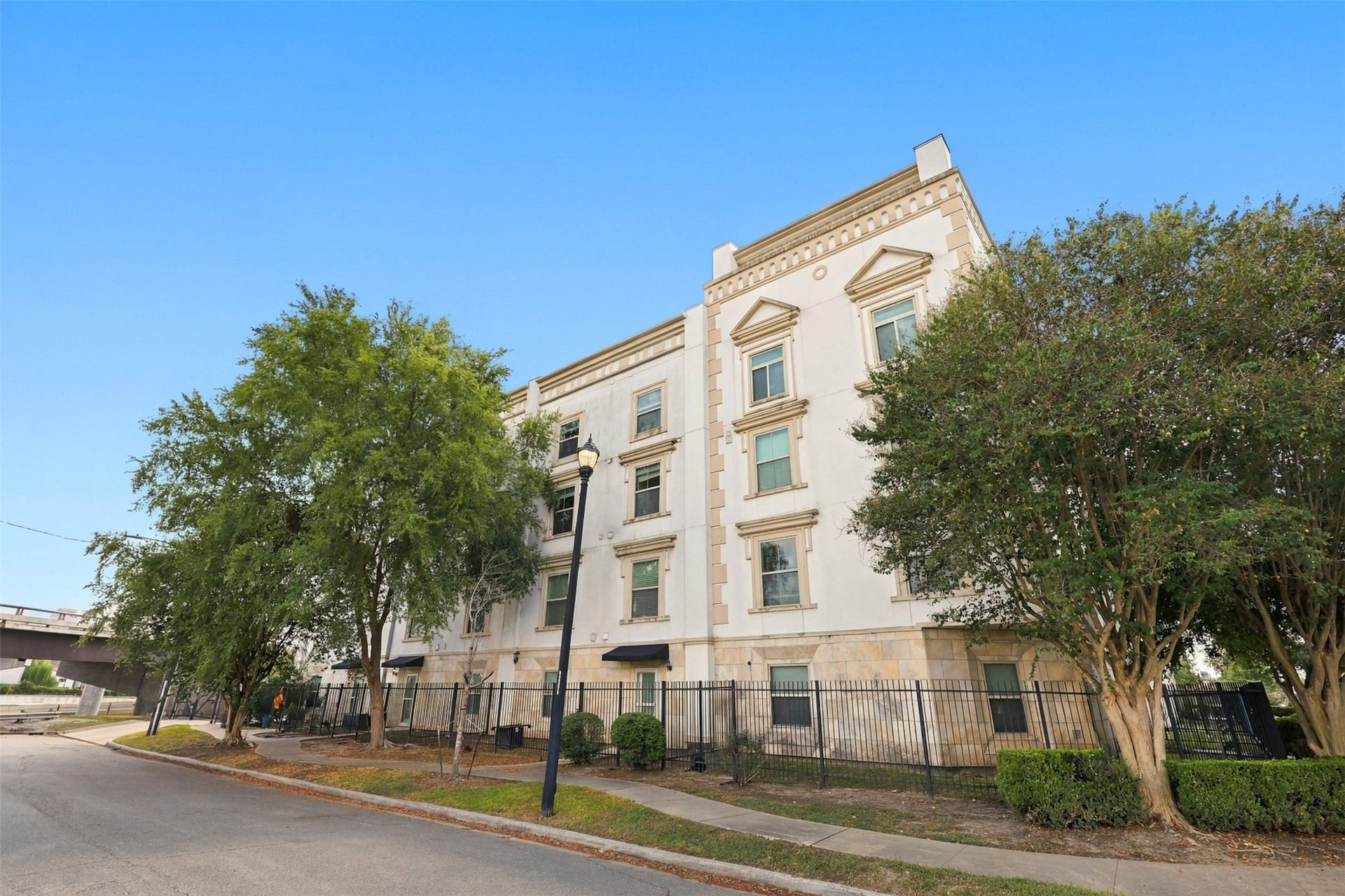 3501 Chenevert Street, #3, Houston, TX 77004 Elegant multi-story building with classic architectural details, surrounded by lush trees and a secure gated entrance.