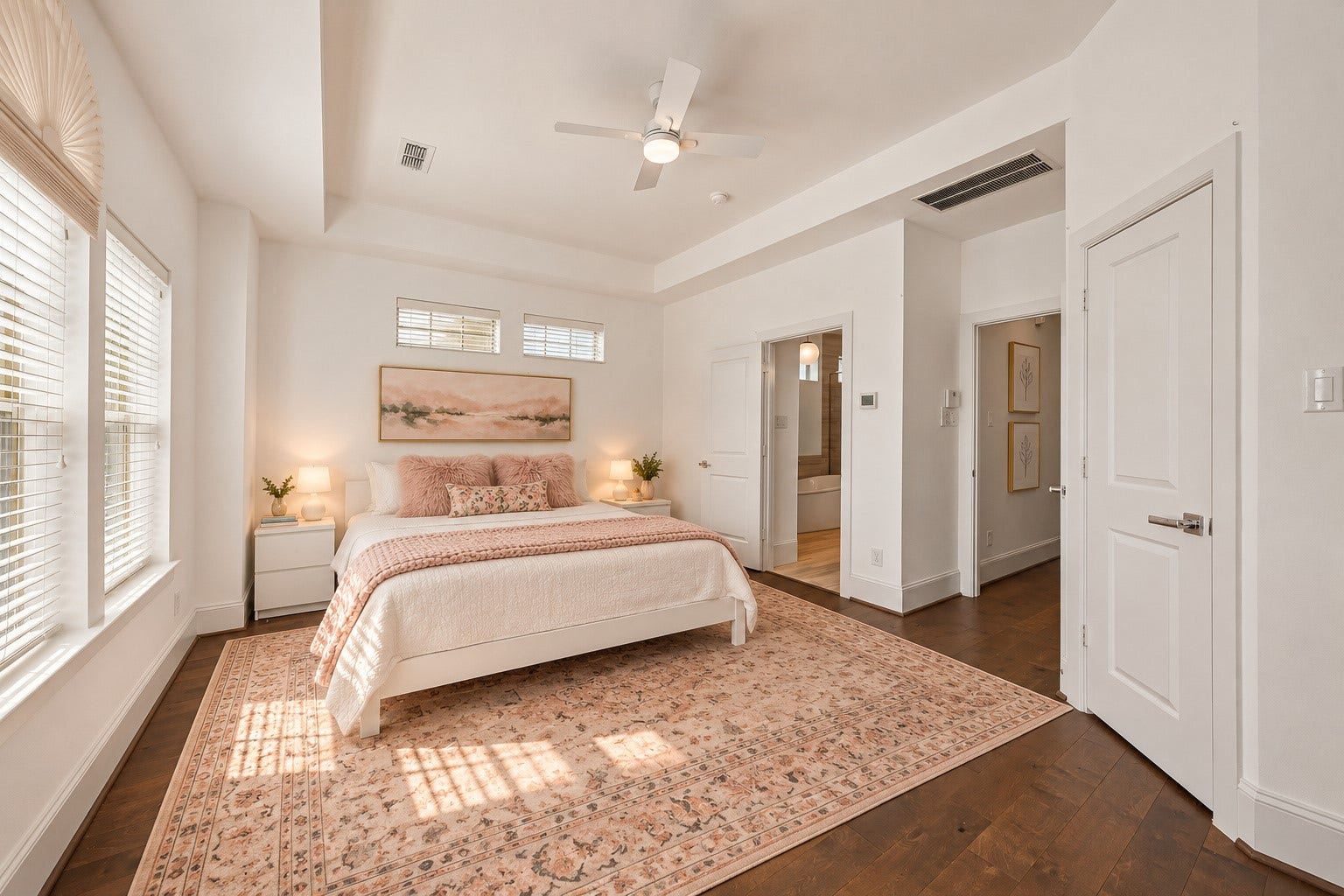 Another perspective of the lovely primary suite highlighting the beautiful tray ceiling, abundant natural light & generous room dimensions. Thoughtfully designed w/ an additional walk-in closet within the bedroom, plus a separate walk-in closet accessible through the primary bath! Wonderful combination of comfort, privacy & storage on the home's 3rd level. Virtually staged.