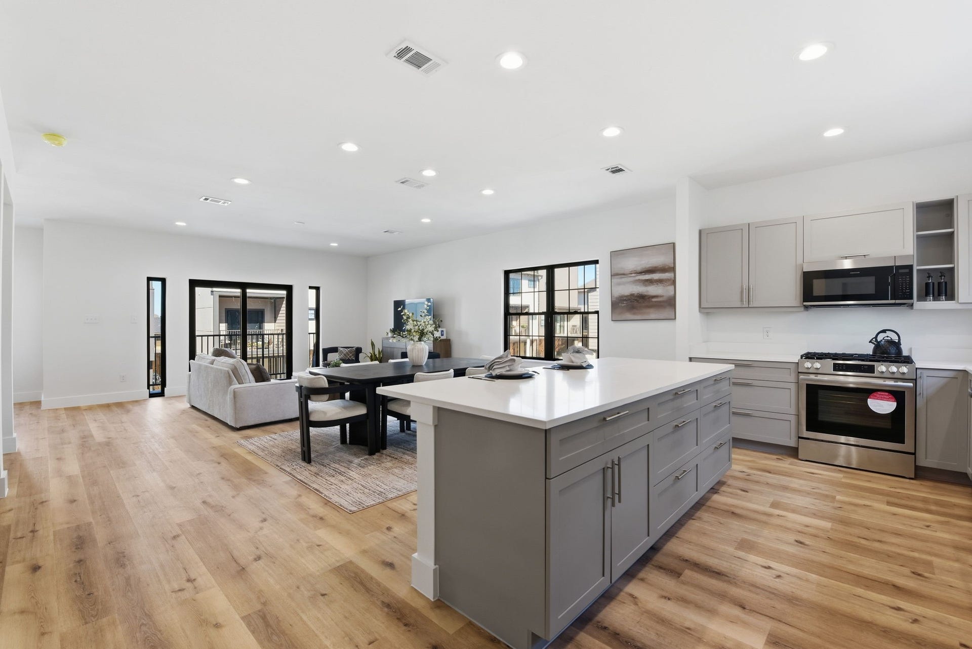 11930 S Hoa Sen Circle, Houston, TX 77072 Oversized quartz countertop with bar seating, perfect for entertaining and casual gatherings. (Photos are from the Model Home - and for representation only)