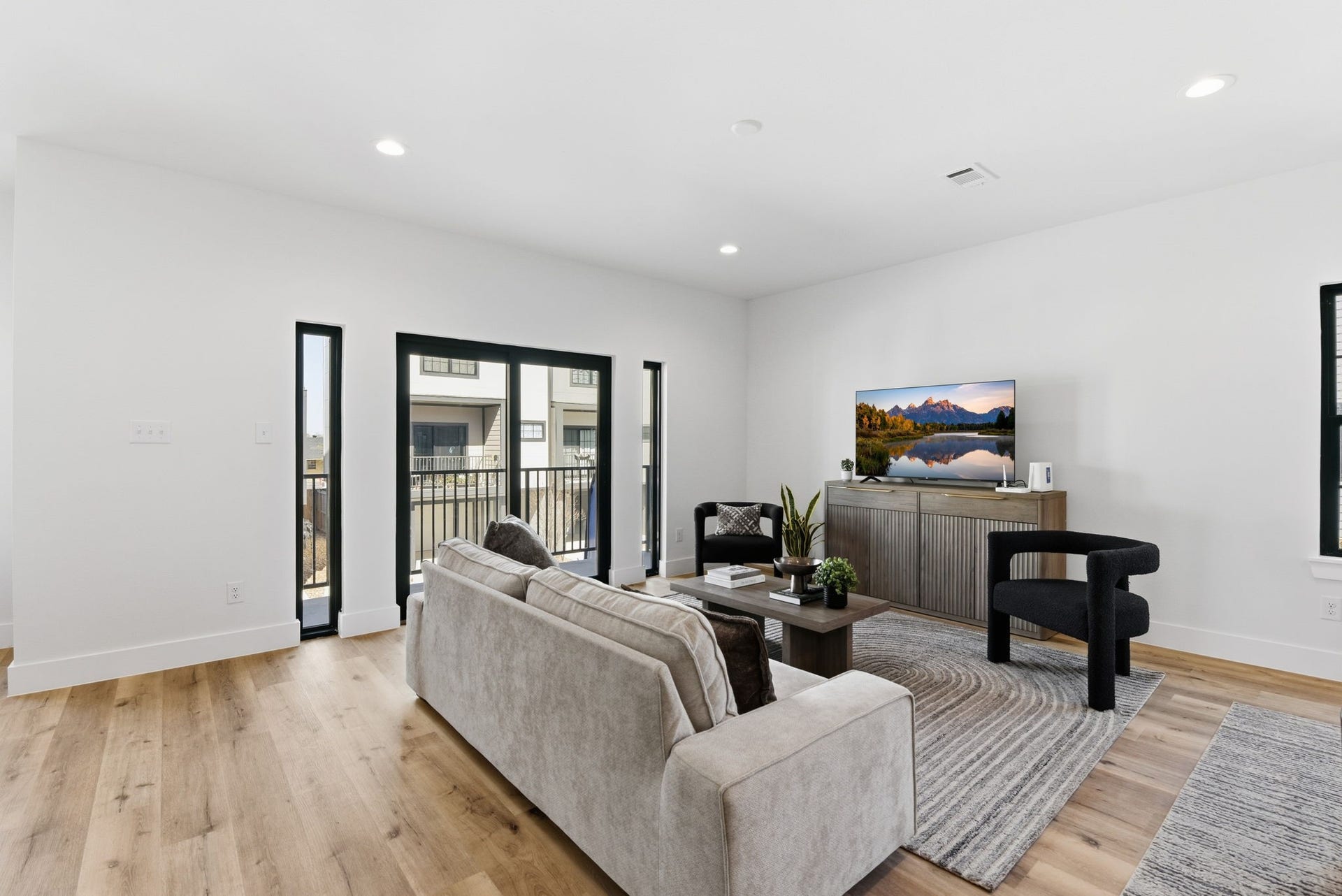 11930 S Hoa Sen Circle, Houston, TX 77072 Sleek sliding doors opening to a private balcony, filling the space with natural light.