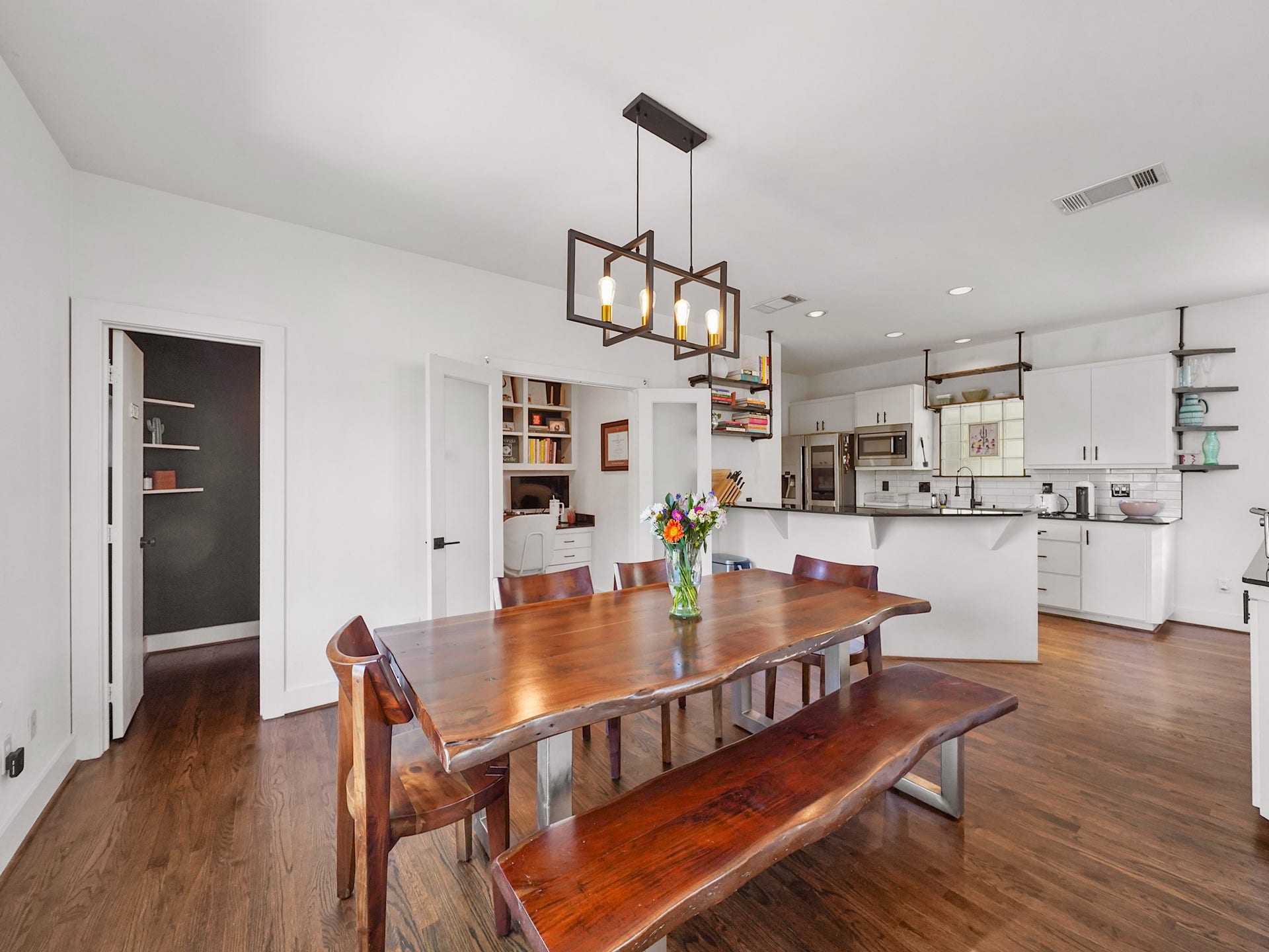 Discover a versatile open dining space seamlessly connected to a functional work station, ideal for effortless multitasking.