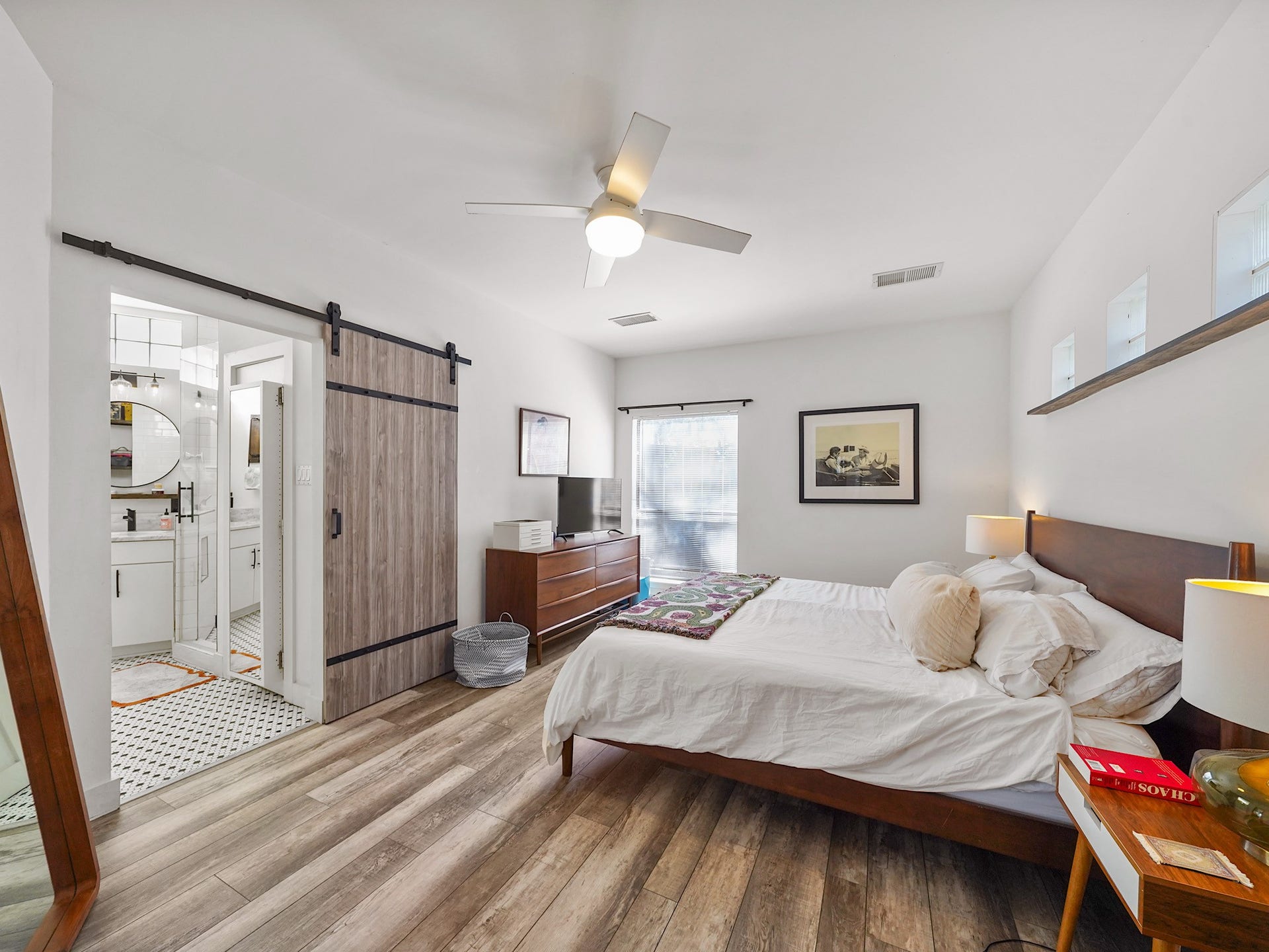 Discover a spacious primary suite awash in natural light, offering a serene retreat with elegant design touches.