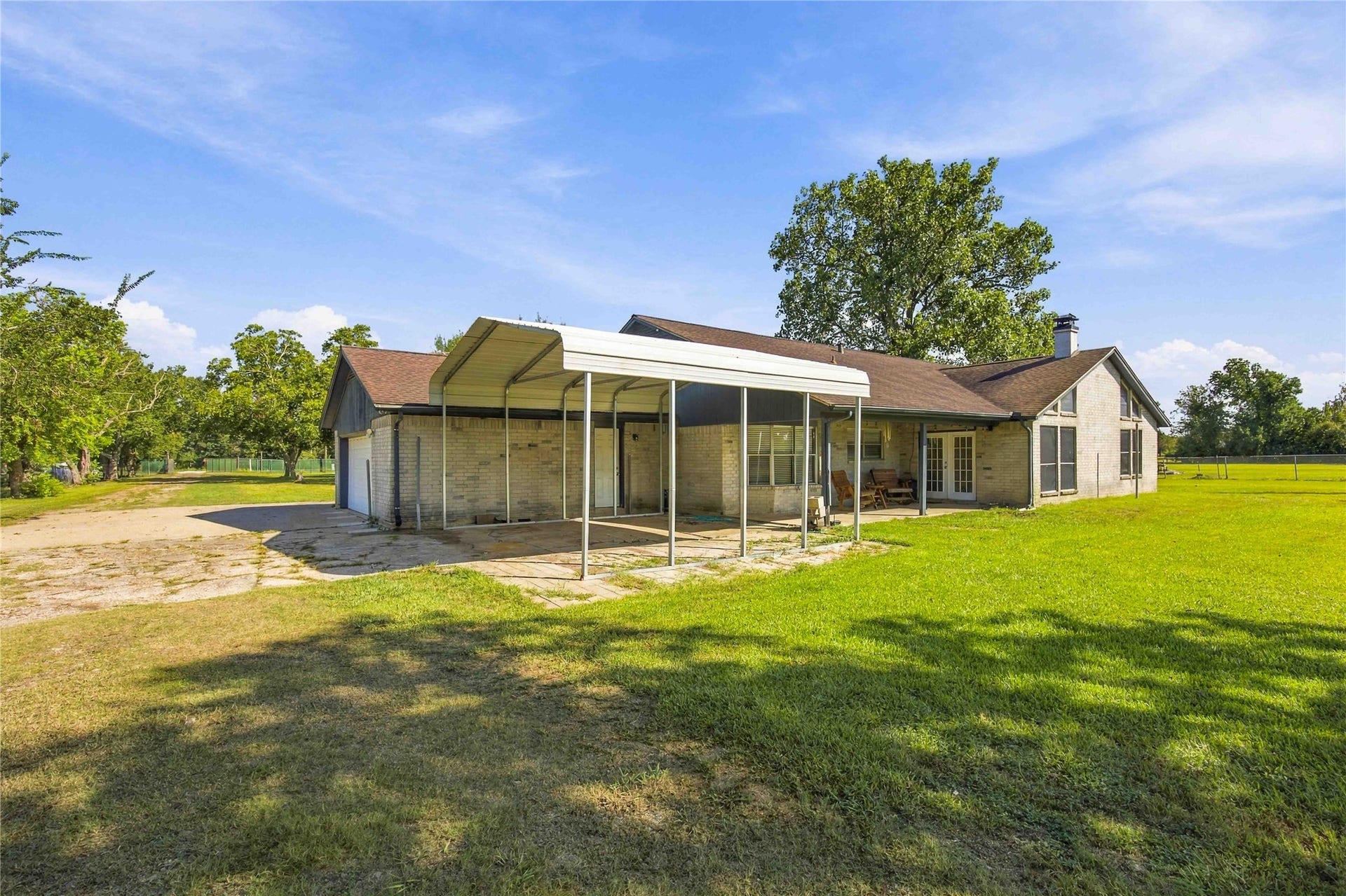 4697 Wickwillow Lane, Alvin, TX 77511 Sitting on the back Patio in the rolling chairs enjoying your view of the Elm, Cypress and Maoplke trees.