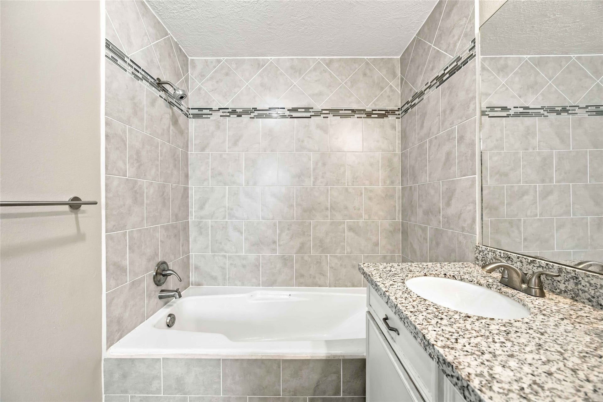 4697 Wickwillow Lane, Alvin, TX 77511 Insert tile in both the tub/shower combo and the separate shower.