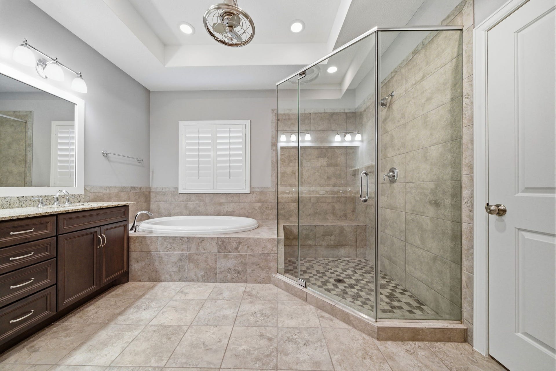 4926 Ella Boulevard, Houston, TX 77018 Other view of the primary bathroom features a spacious layout with a large glass-enclosed shower, a soaking tub, and a double-sink vanity with granite countertops. The neutral tile and recessed lighting create a bright, modern atmosphere.