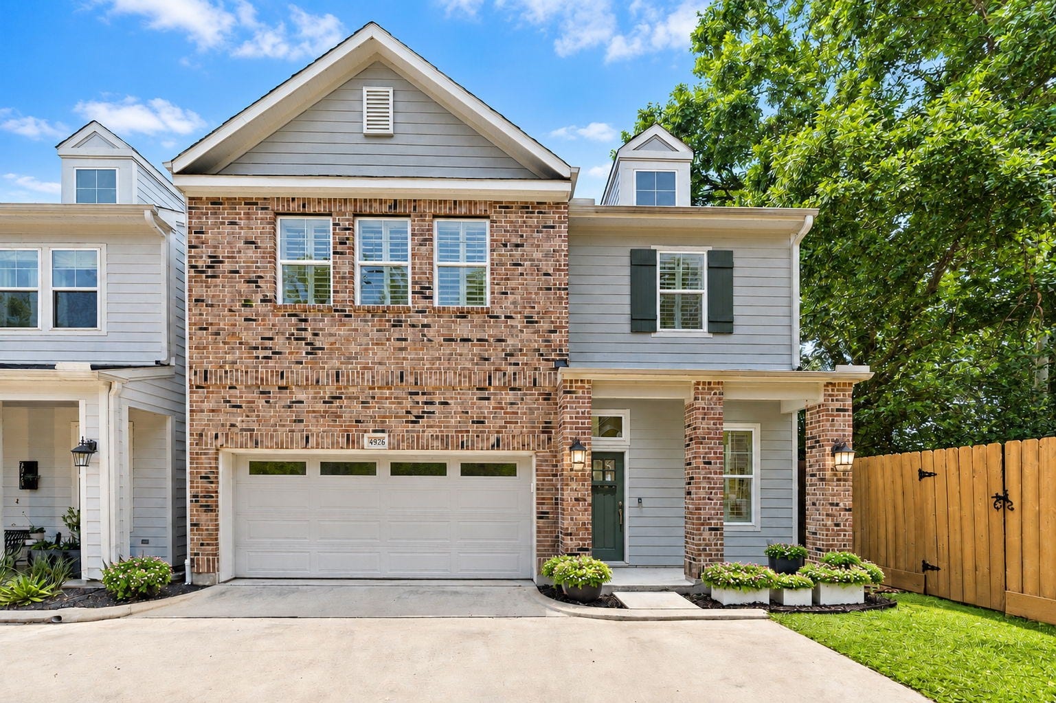 4926 Ella Boulevard, Houston, TX 77018 Charming two-story home with a brick faade in a small gated community. It features a two-car garage, a welcoming front porch, and attractive landscaping.