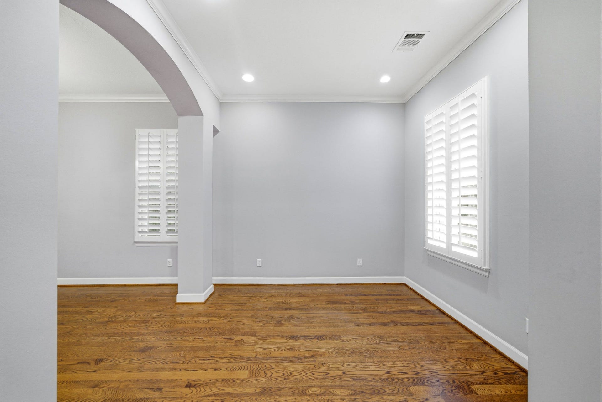 4926 Ella Boulevard, Houston, TX 77018 Other view of the study and hardwood floors, soft gray/blue walls, and white crown molding. It has recessed lighting and large windows with plantation shutters, creating a bright and inviting space.