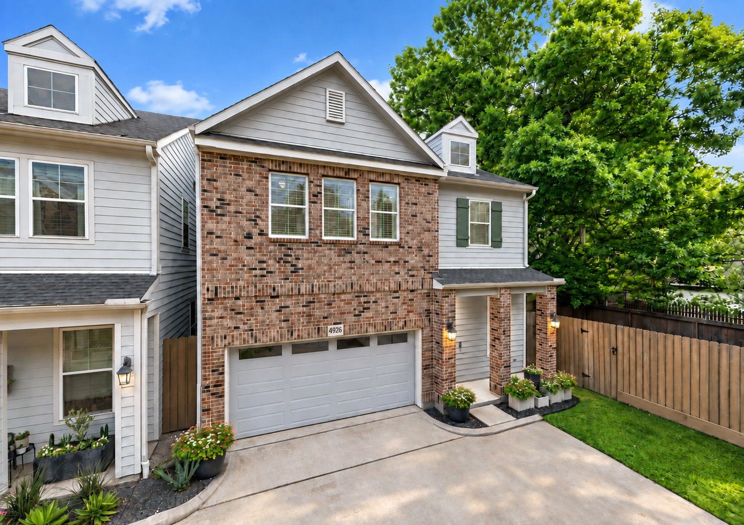 4926 Ella Boulevard, Houston, TX 77018 Charming two-story home with a brick faade in a small gated community. It features a two-car garage, a welcoming front porch, and attractive landscaping.