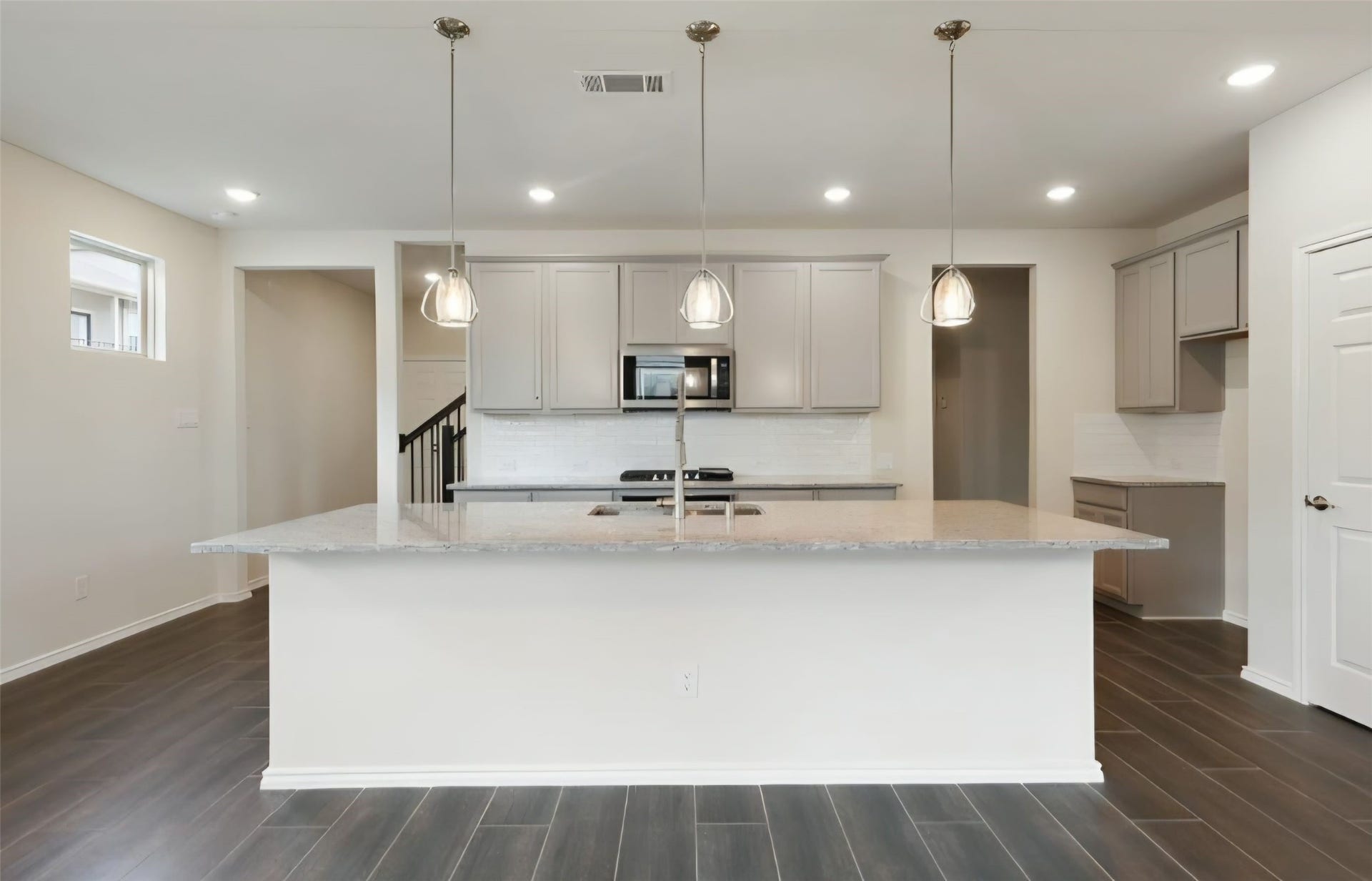 3104 Dakota Falls Drive, Houston, TX 77063 Kitchen island has elegant hanging pendant lighting