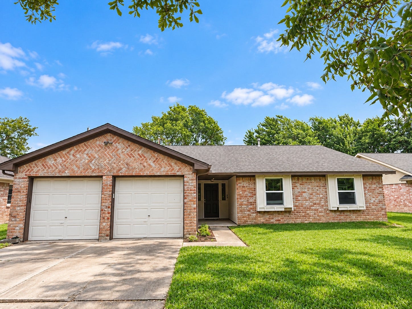 2026 Arcadia Drive, Sugar Land, TX 77498 Front Exterior: Classic single-story brick home with a two-car garage, mature landscaping, and welcoming curb appeal.