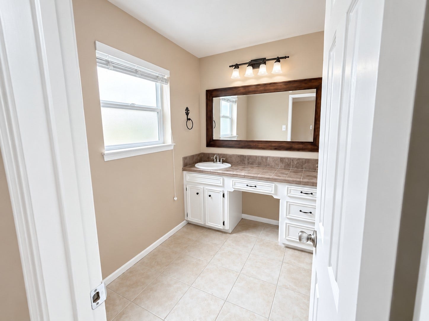 2026 Arcadia Drive, Sugar Land, TX 77498 Bathroom Vanity: Bright vanity area with abundant counter and cabinet space, a large mirror, and clean neutral finishes.