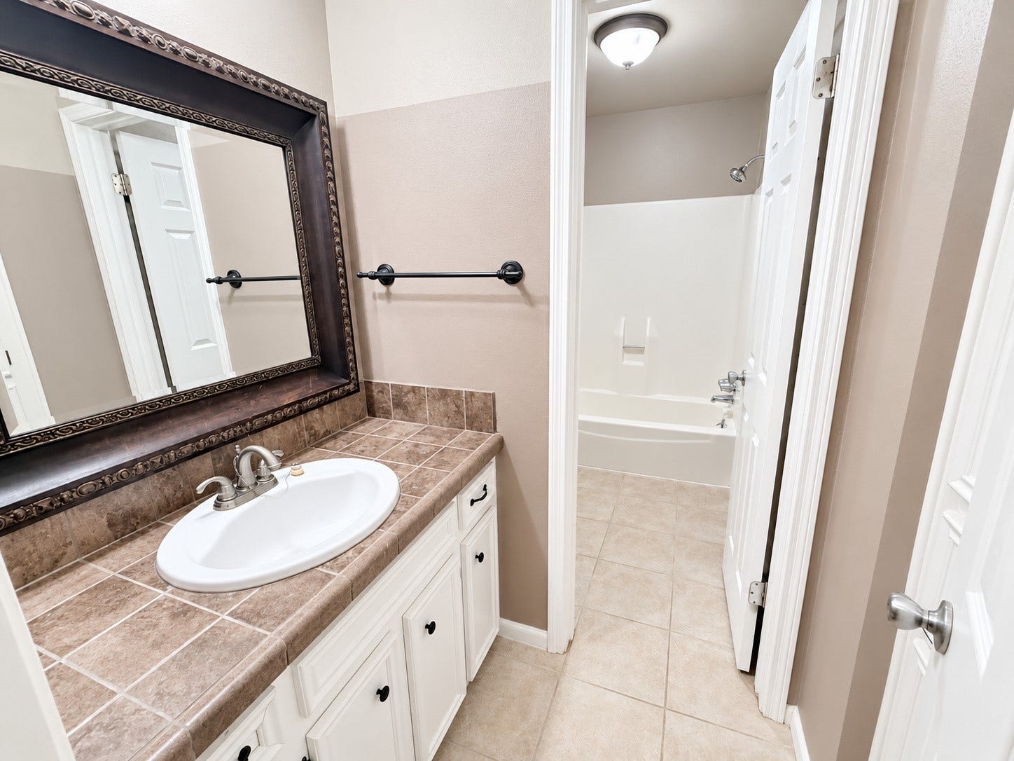 2026 Arcadia Drive, Sugar Land, TX 77498 Bathroom with Tub: Well-designed bathroom featuring a generous vanity, tub/shower area, and plenty of natural-looking light.
