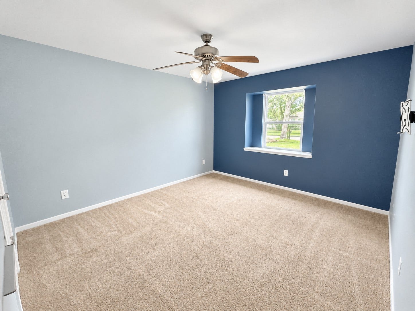 2026 Arcadia Drive, Sugar Land, TX 77498 Secondary Bedroom Blue Accent: Comfortable secondary bedroom with a stylish accent wall, large window, and plenty of natural light.