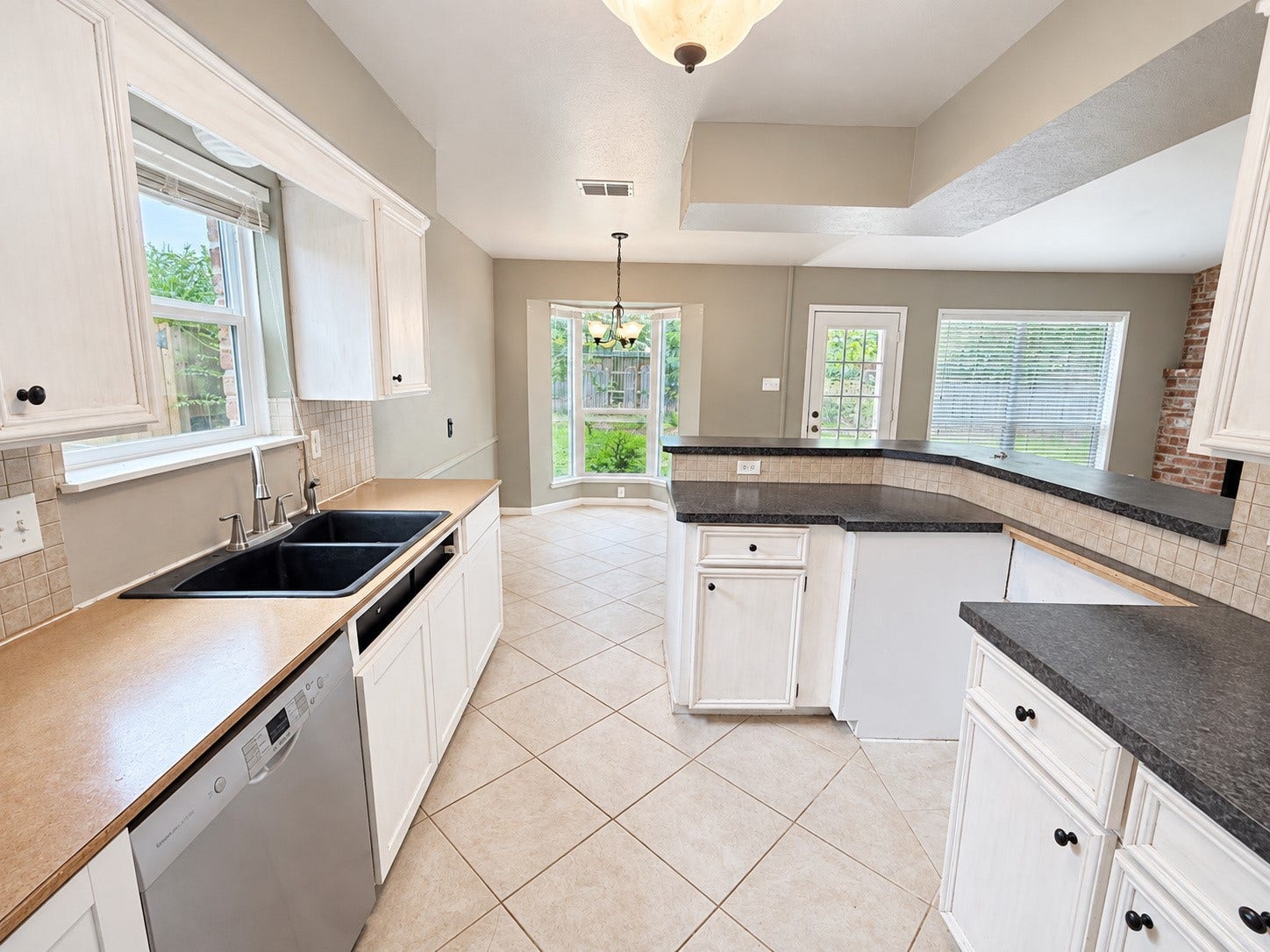 2026 Arcadia Drive, Sugar Land, TX 77498 Kitchen & Dining Area: Bright, open kitchen and dining space with abundant natural light, a functional breakfast bar, and plenty of room for everyday living and entertaining.