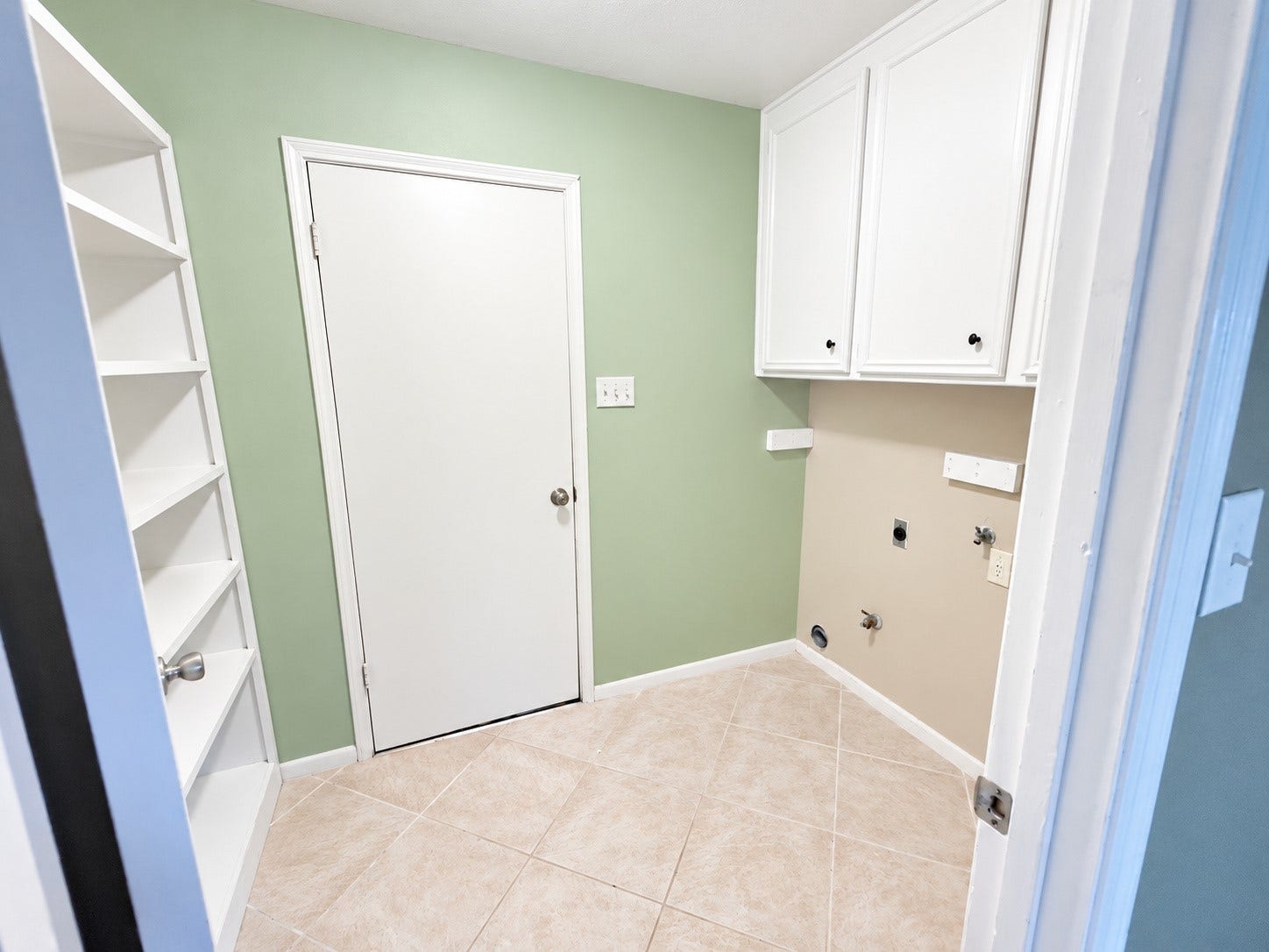 2026 Arcadia Drive, Sugar Land, TX 77498 Utility/Laundry Room: Dedicated laundry and utility room with built-in cabinetry and shelving for convenient storage and organization.