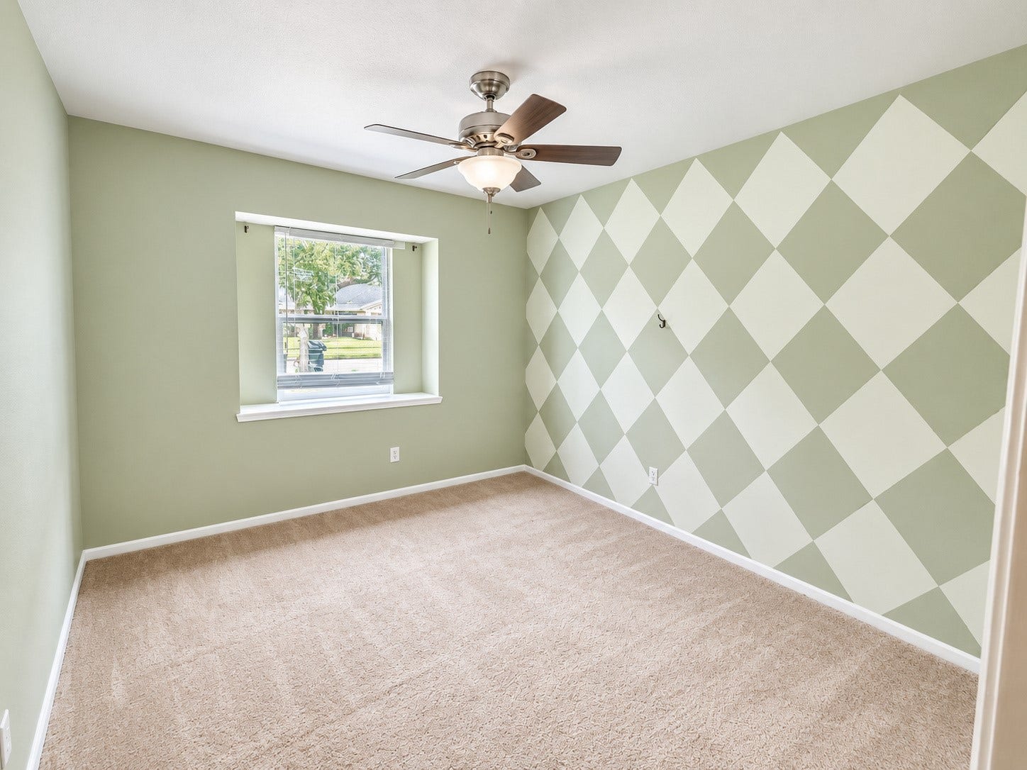 2026 Arcadia Drive, Sugar Land, TX 77498 Secondary Bedroom Patterned Accent Wall: Cheerful secondary bedroom with a unique accent wall, bright window, and flexible space for guests, kids, or a home office.