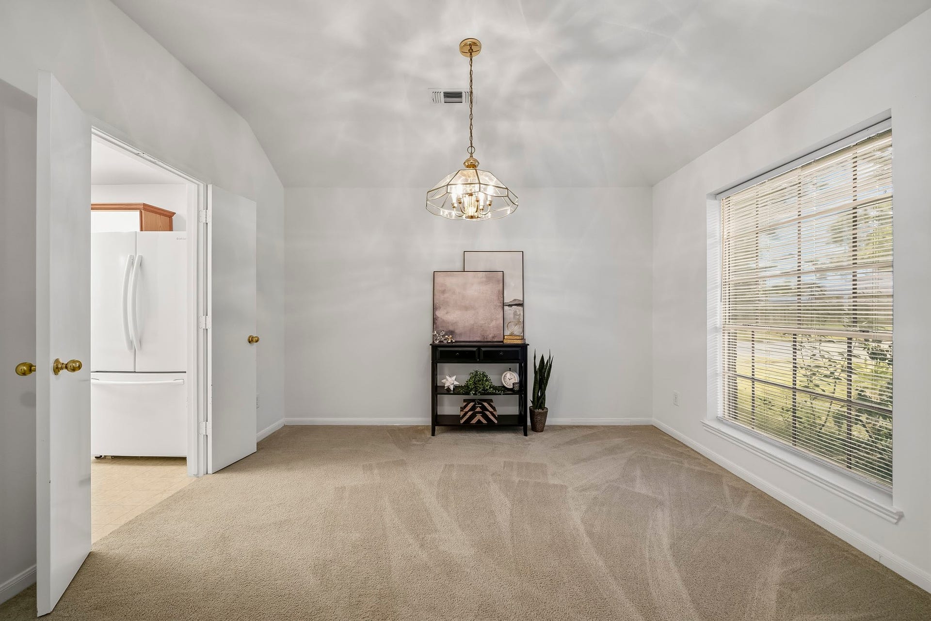 16831 Dunbar Grove Ct, Sugar Land, TX 77498 The formal dining room offers a dedicated space for gathering with family and friends, while double doors provide convenient access to the kitchen when entertaining.