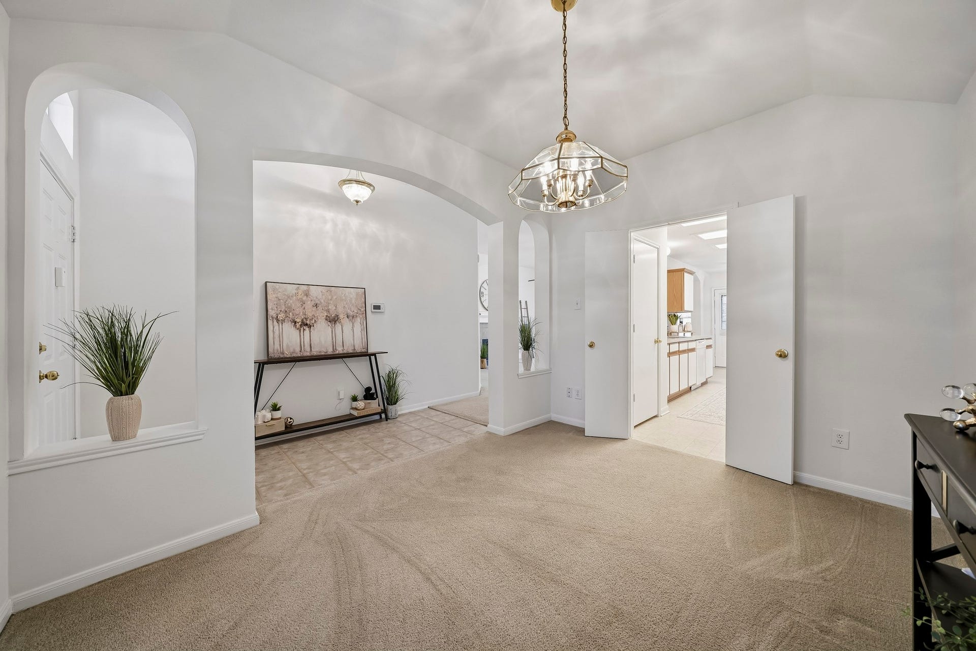 16831 Dunbar Grove Ct, Sugar Land, TX 77498 Another view of the formal dining room highlights the elegant chandelier and the two decorative art niches that add character and architectural interest to the space.