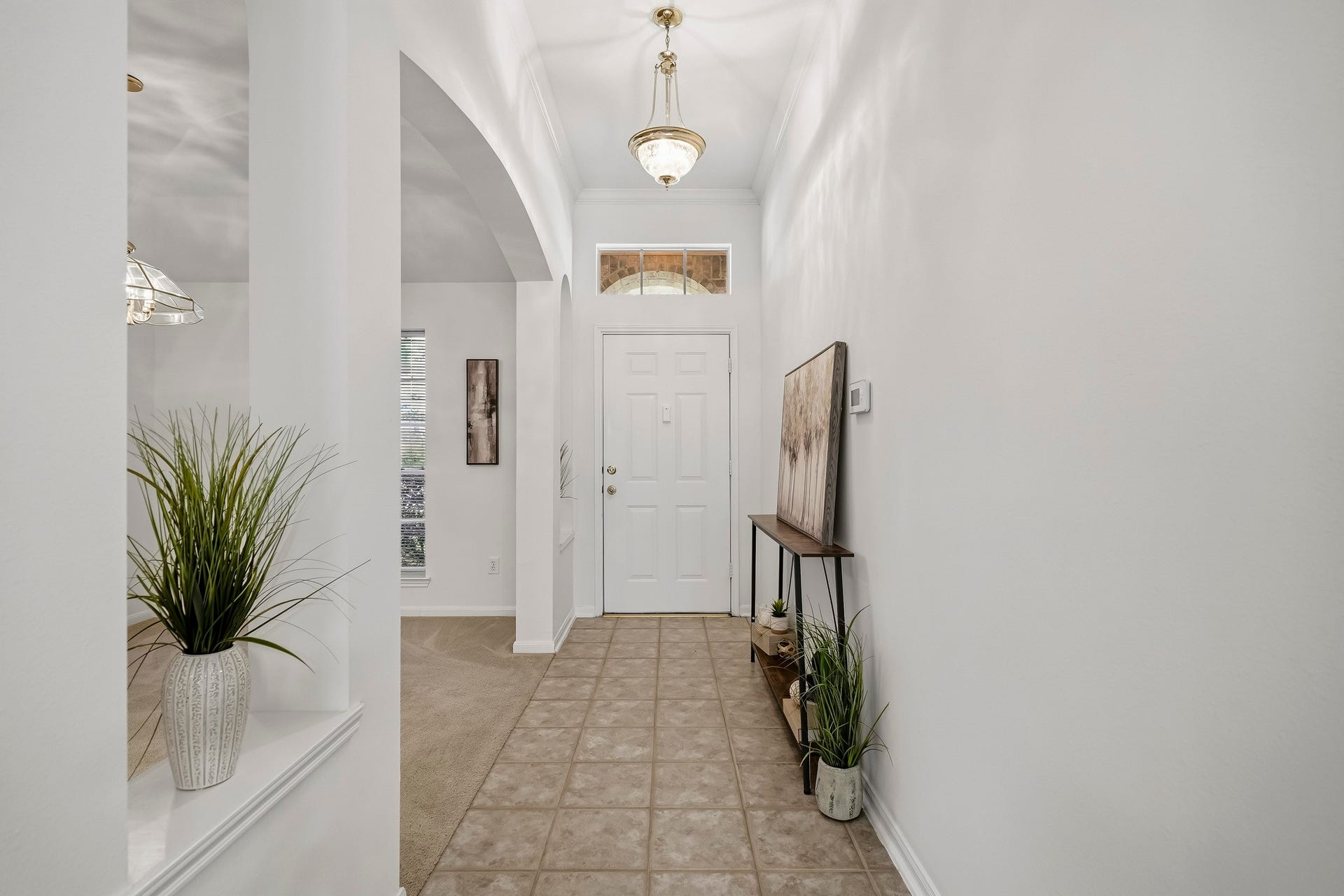 16831 Dunbar Grove Ct, Sugar Land, TX 77498 A transom window above the front door brings additional natural light into the entry. An all-glass storm door (not pictured) also allows you to open the front door and enjoy the view while still keeping the home enclosed.