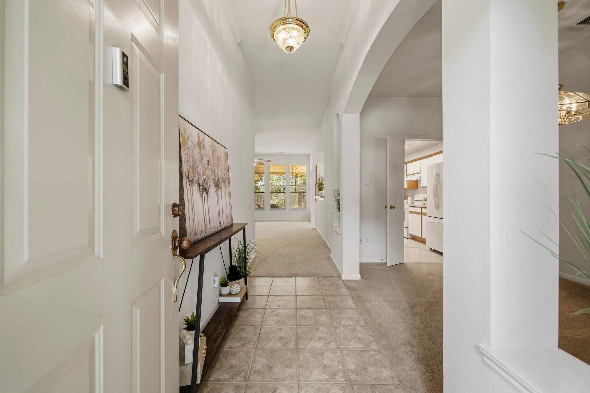 16831 Dunbar Grove Ct, Sugar Land, TX 77498 Step inside to a light, bright and welcoming interior. The foyer features neutral tile flooring and an elevated light fixture, with the formal dining room just off the entry and views extending into the sun-filled family room.