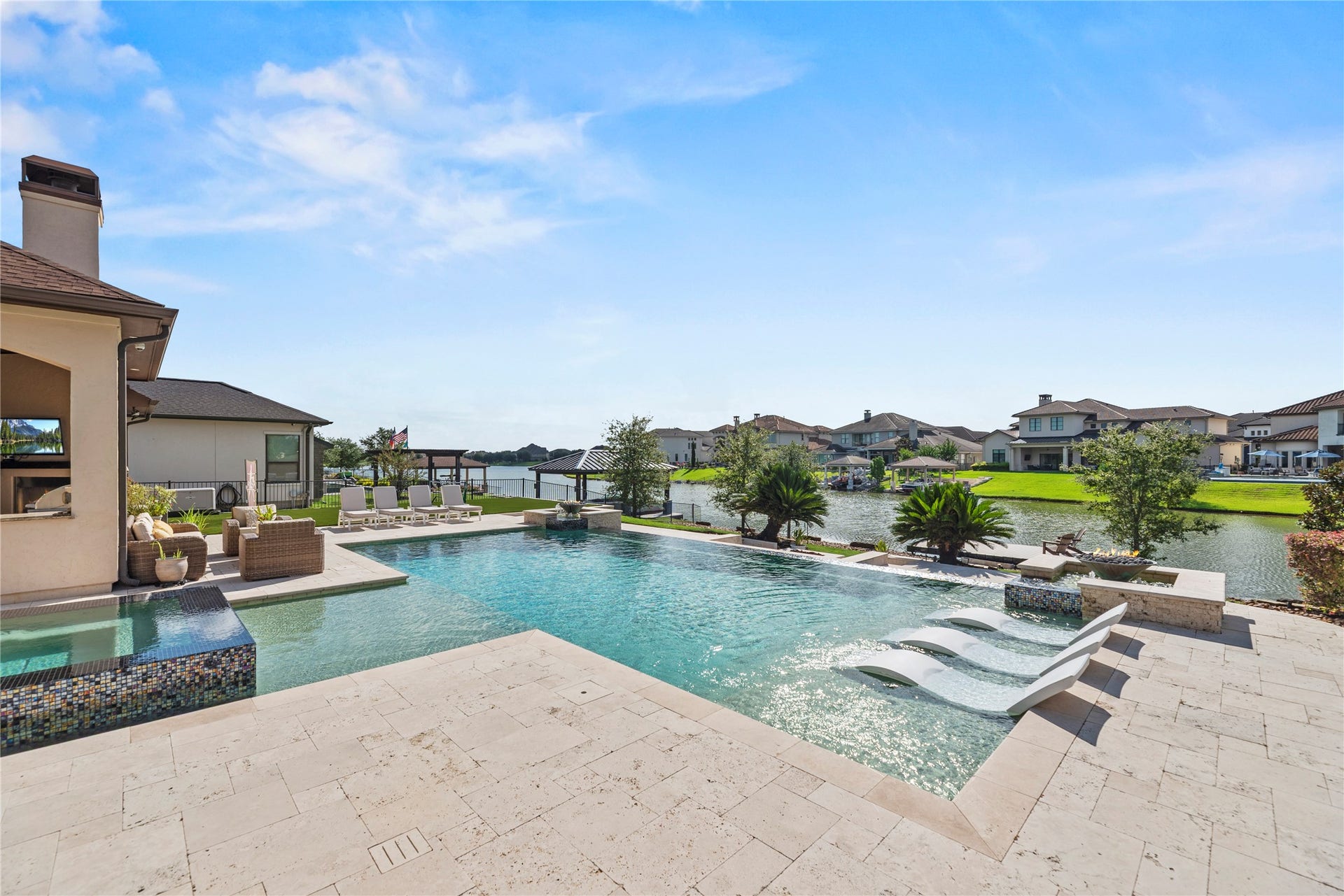 10314 Joshua Creek Court, Cypress, TX 77433 A spectacular lakefront setting where the resort-style pool, sun shelf and expansive patio create a private outdoor escape with beautiful water views.