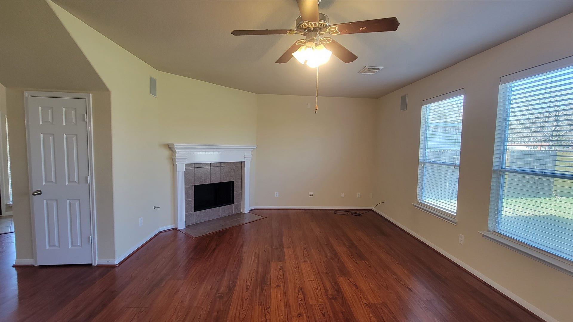 2502 Quiet Sage Lane, Katy, TX 77494 Cozy living room with a warm wooden floor and inviting fireplace.