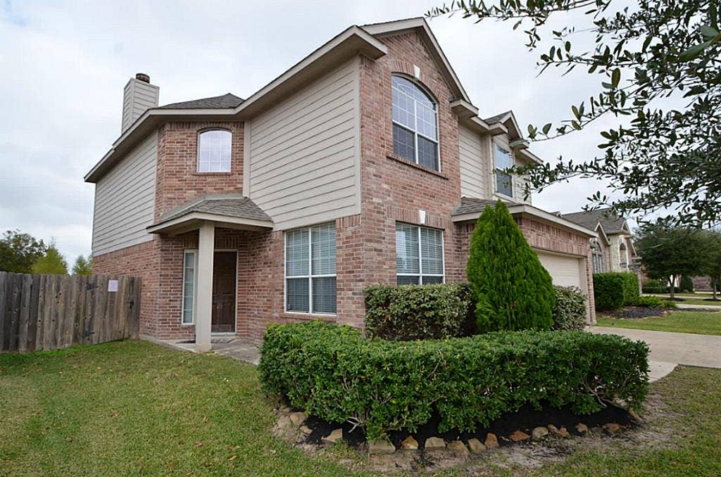 2502 Quiet Sage Lane, Katy, TX 77494 Stylish two-story home featuring elegant brown brick exterior.